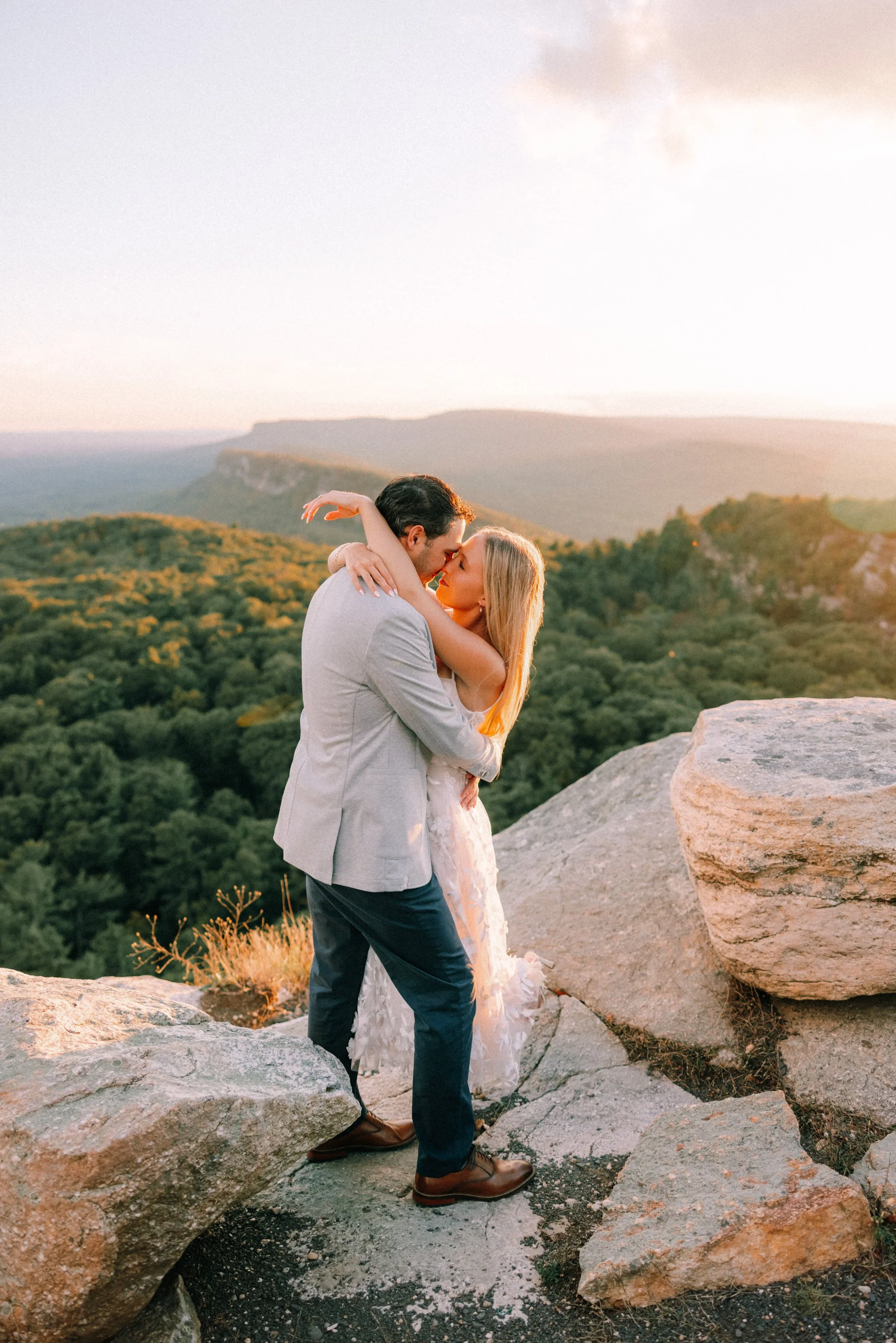 couple embrace at Sky Top during their engagement photo shoot at Mohonk Mountain House
