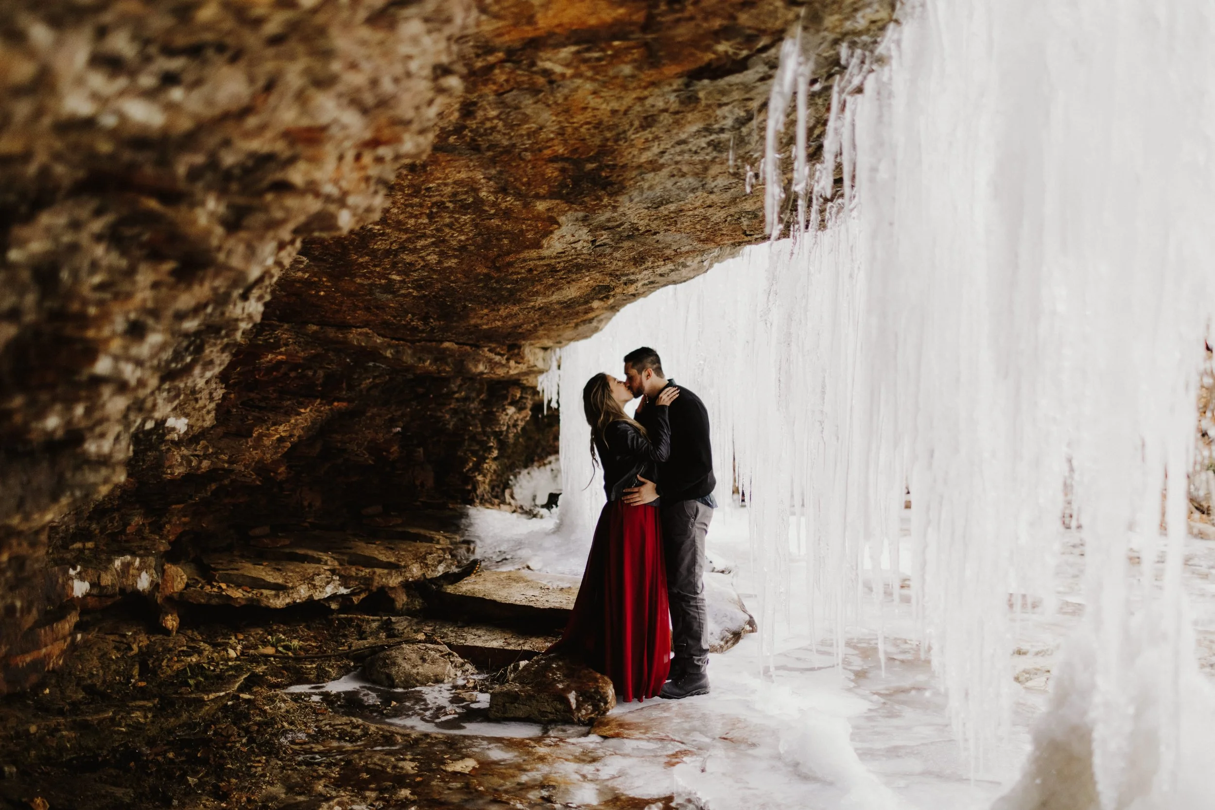 couple under ice cave during their engagement photo shoot at Minnewaska State park