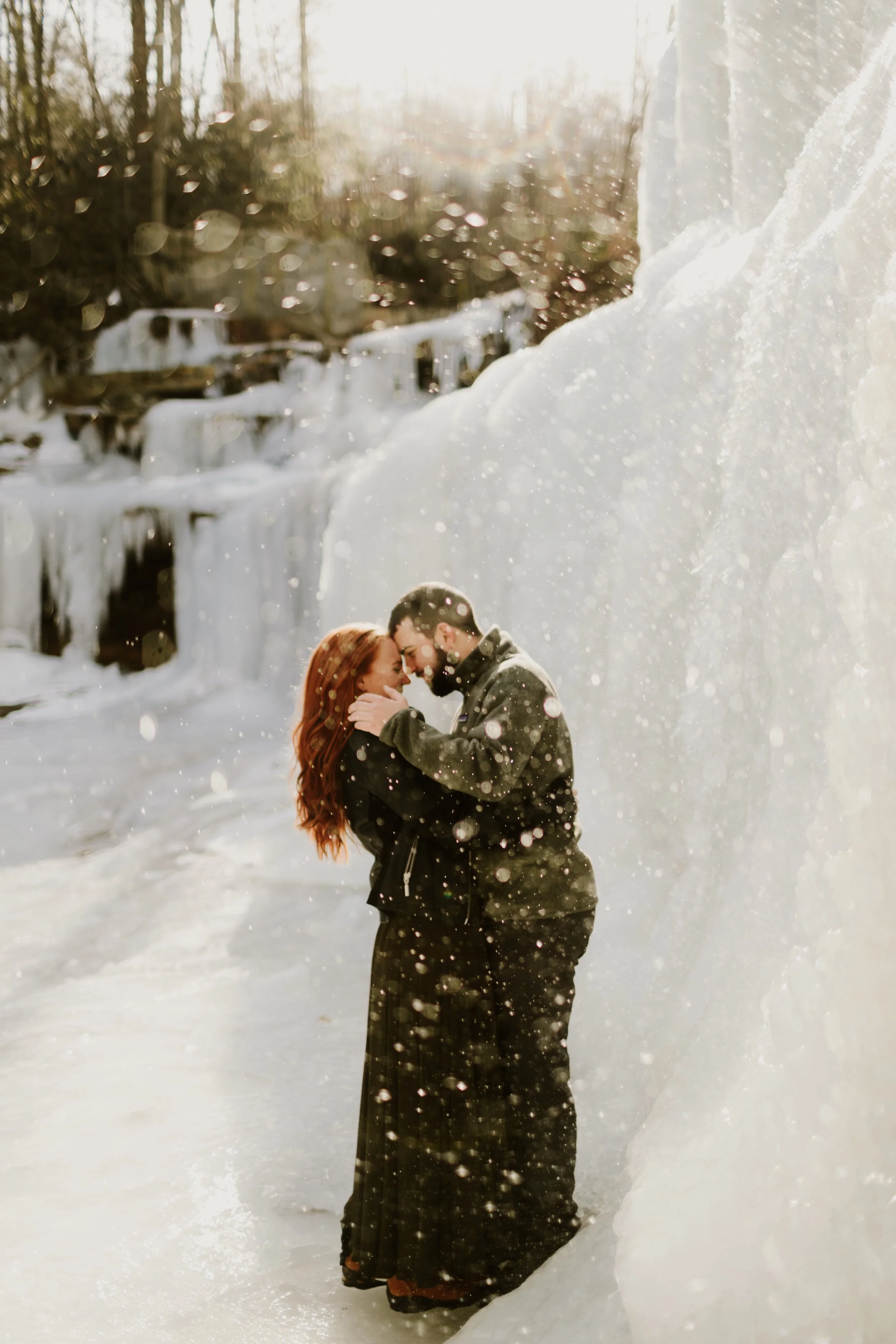 couple on ice during their winter engagement shoot on a frozen waterfall in Minnewaska State Park