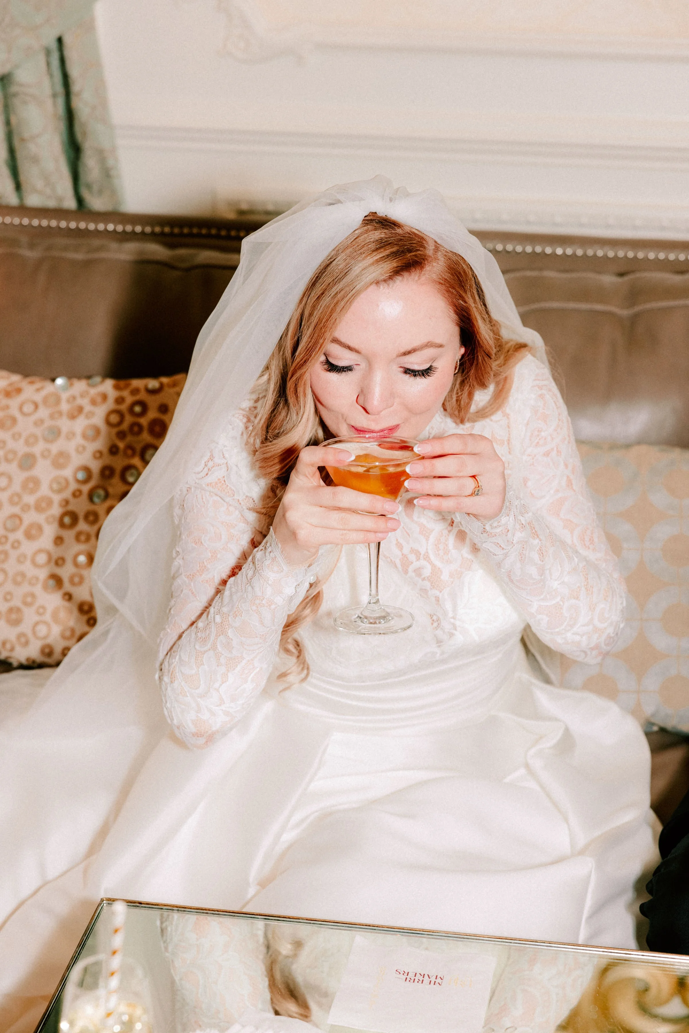 bride sips her martini after her wedding ceremony at the ashford estate