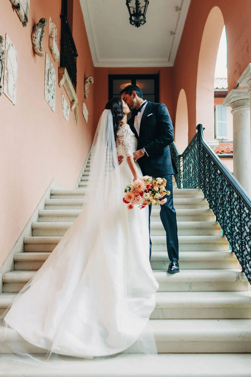 wedding couple kiss and embrace on the stairs at glenmere mansion