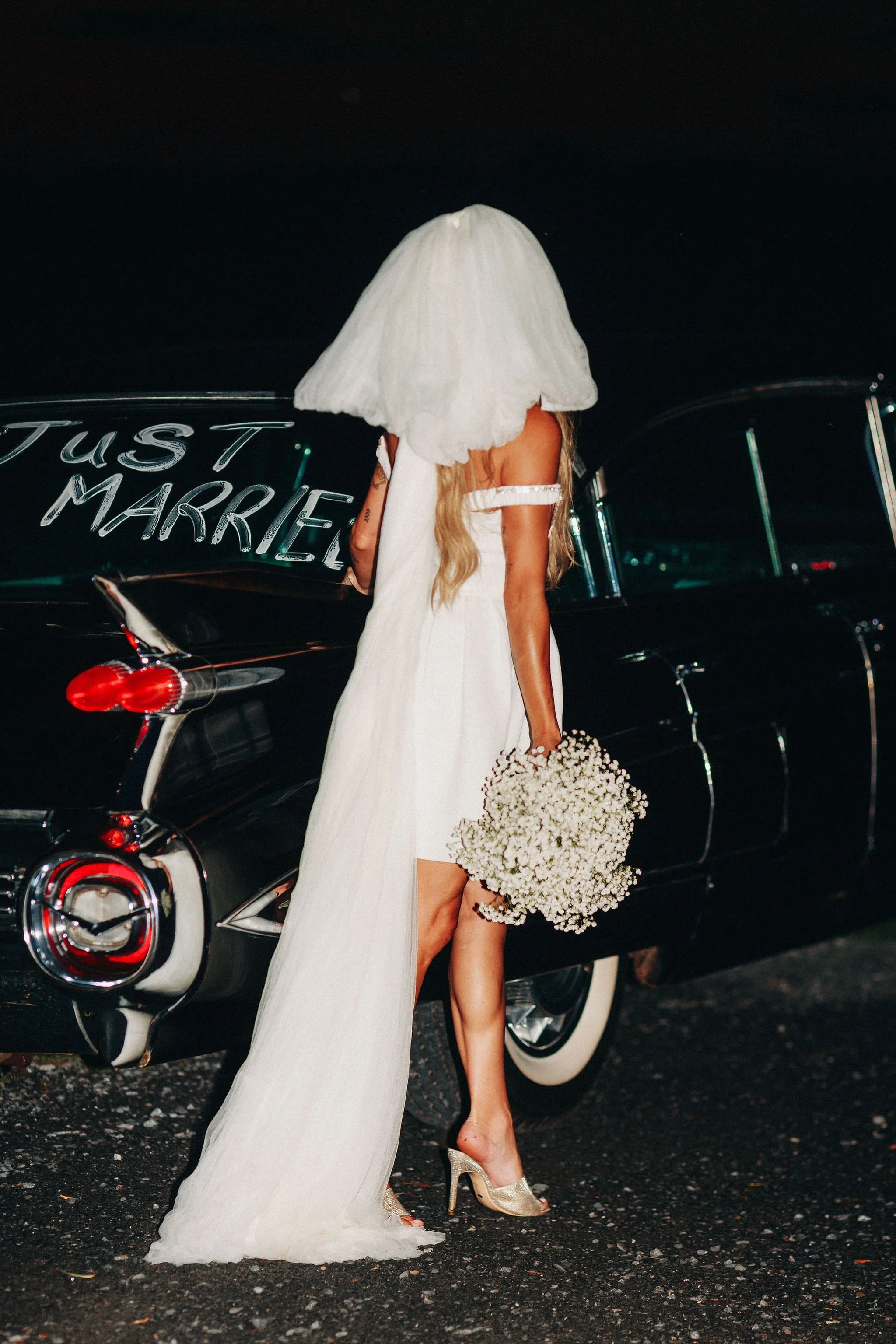 bride standing next to classic car with "just married" written on the back window during her hudson valley elopement