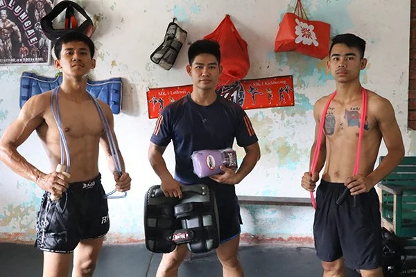 Coach Richard and his two best students with some gear donations from nak muay foundation, Thai pads two ropes and twins gloves for the dedicated young female student who comes everyday