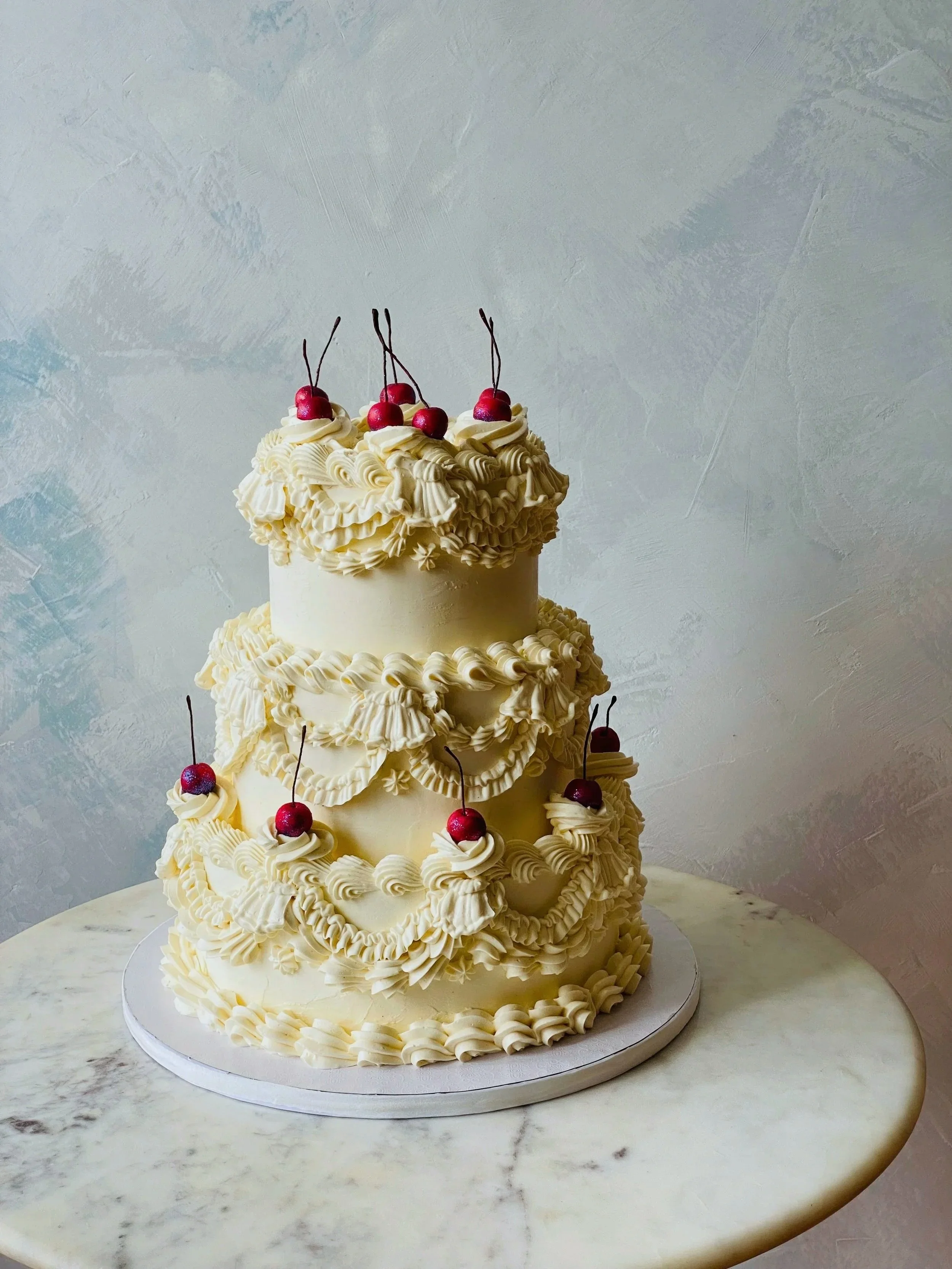Vintage piping wedding cake with disco cherries in NYC. 
