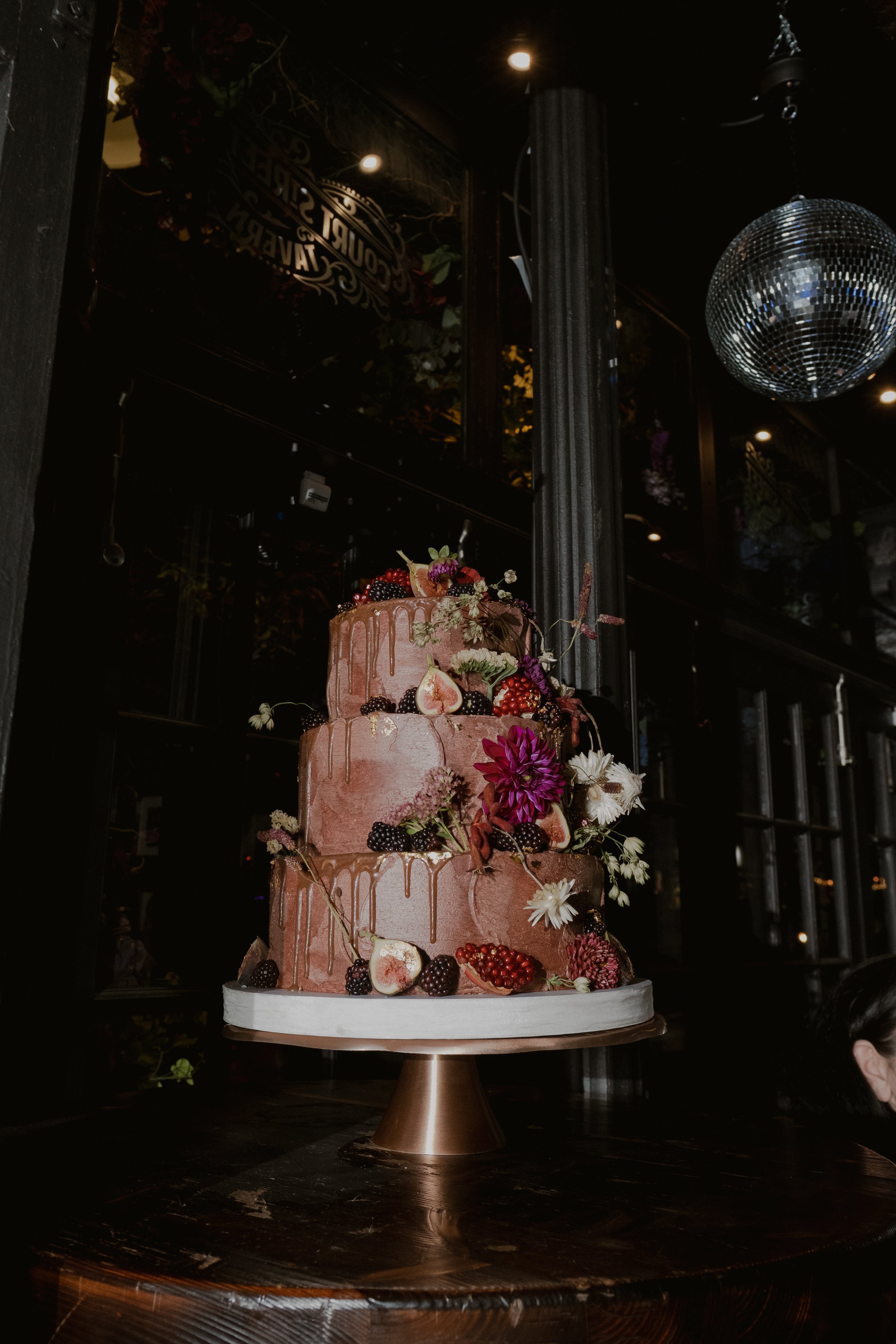 Dark chocolate cake with caramel, gold, figs and moody edible decor with a disco ball in Brooklyn, NYC. 