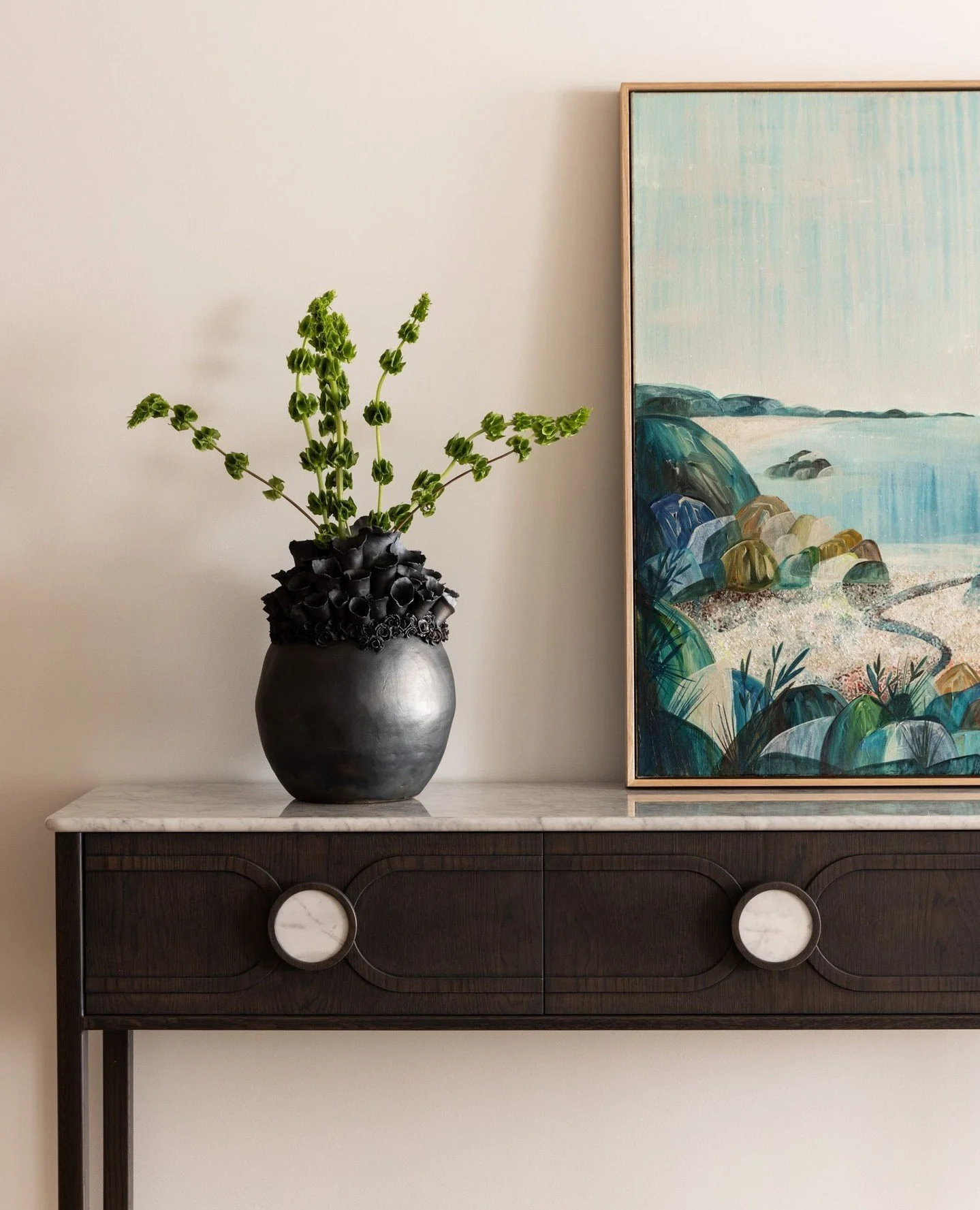 A custom console in slate-stained oak anchors this corner of our Walsh Bay Apartment project.⁠
⁠
We love collaborating with Australian designers and makers to bring bespoke pieces into our projects &mdash; furniture that not only fits seamlessly into