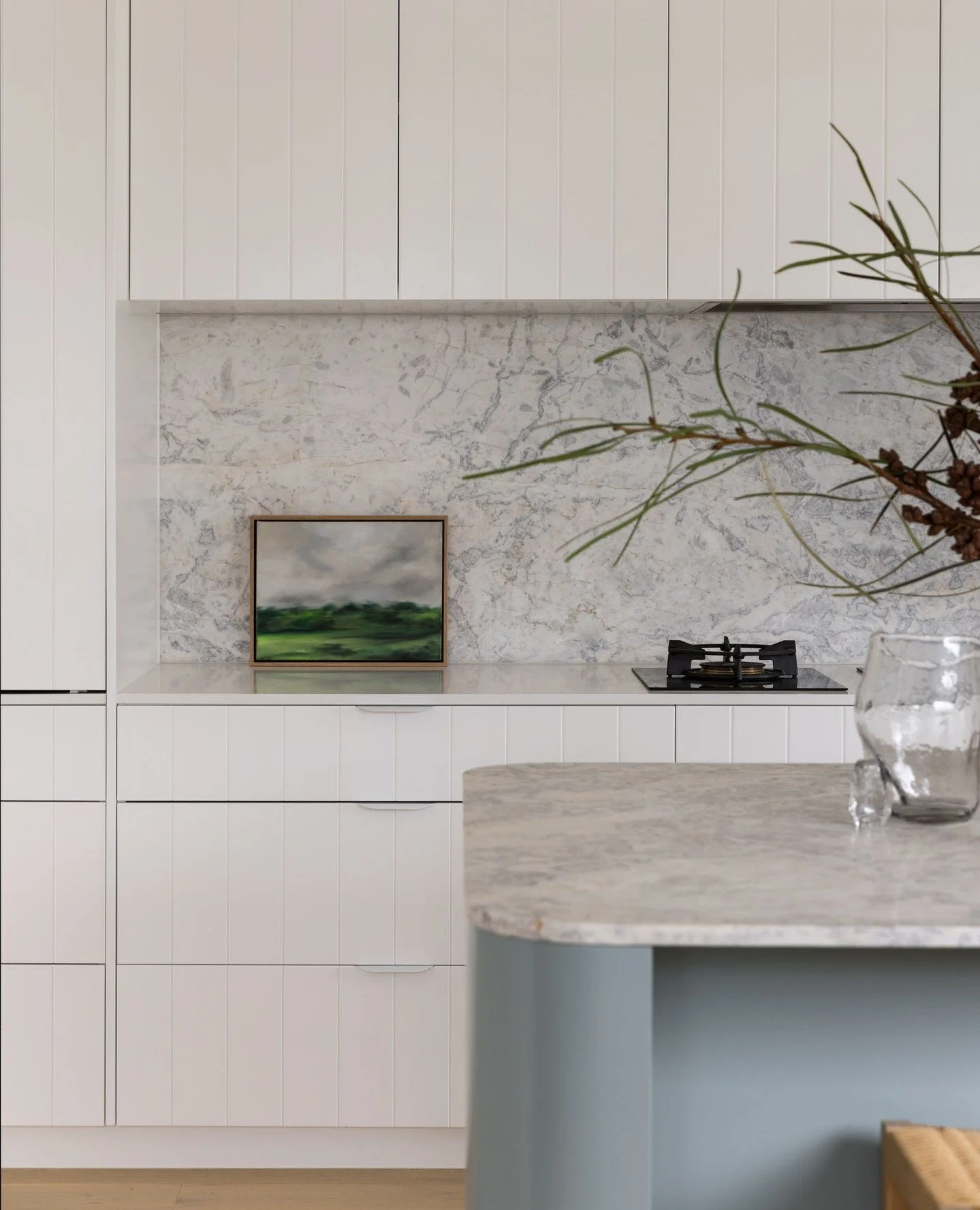 The kitchen and adjoining laundry at our North Avoca Beach House, designed as a calm and considered centre to daily life.⁠
⁠
A restrained material palette brings this space together, with natural stone and soft tonal variation. Every element has been