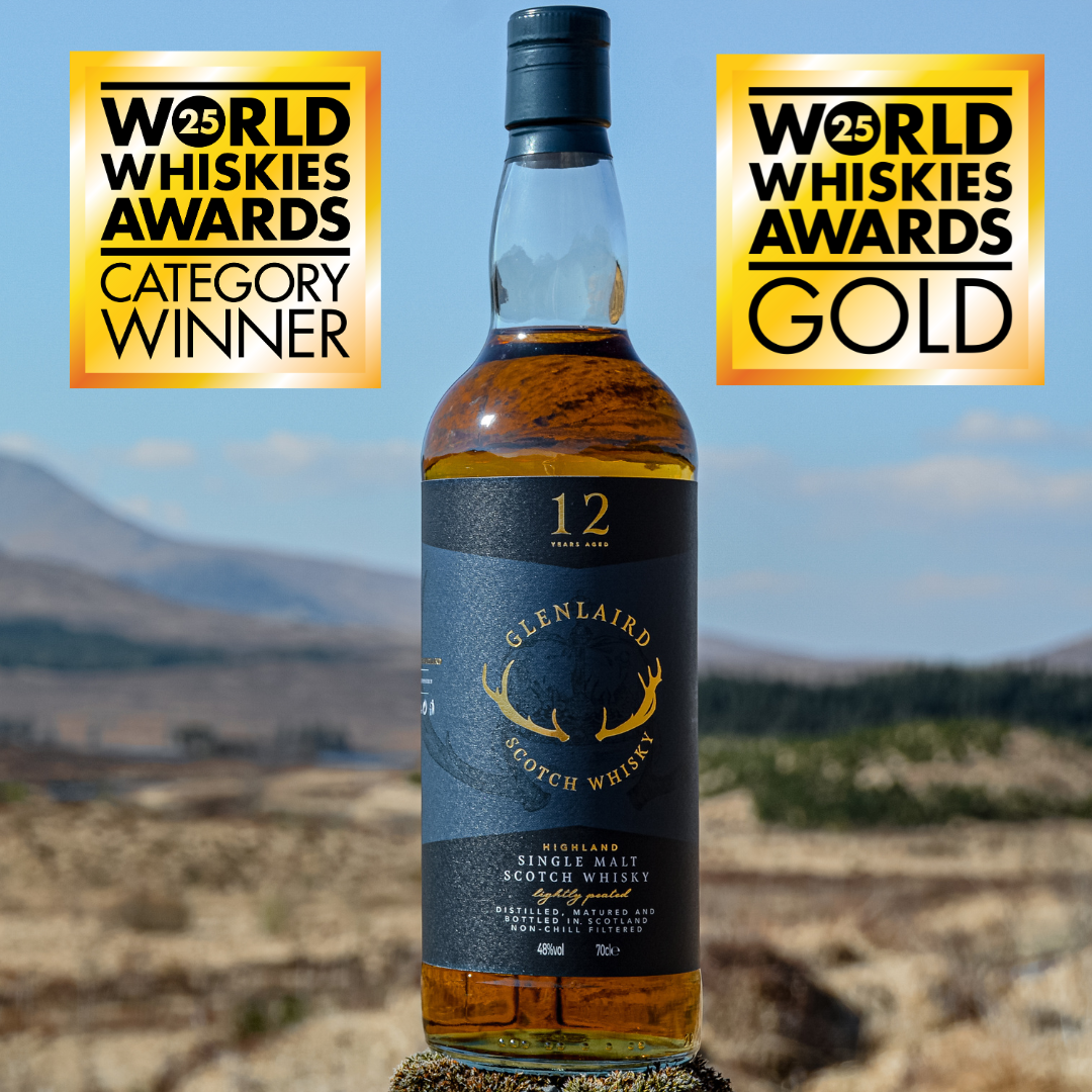 Bottled Glenlaird 12-year-old Highland single malt Scotch whisky outdoors with awards badges indicating category winner and gold at the World Whiskies Awards.