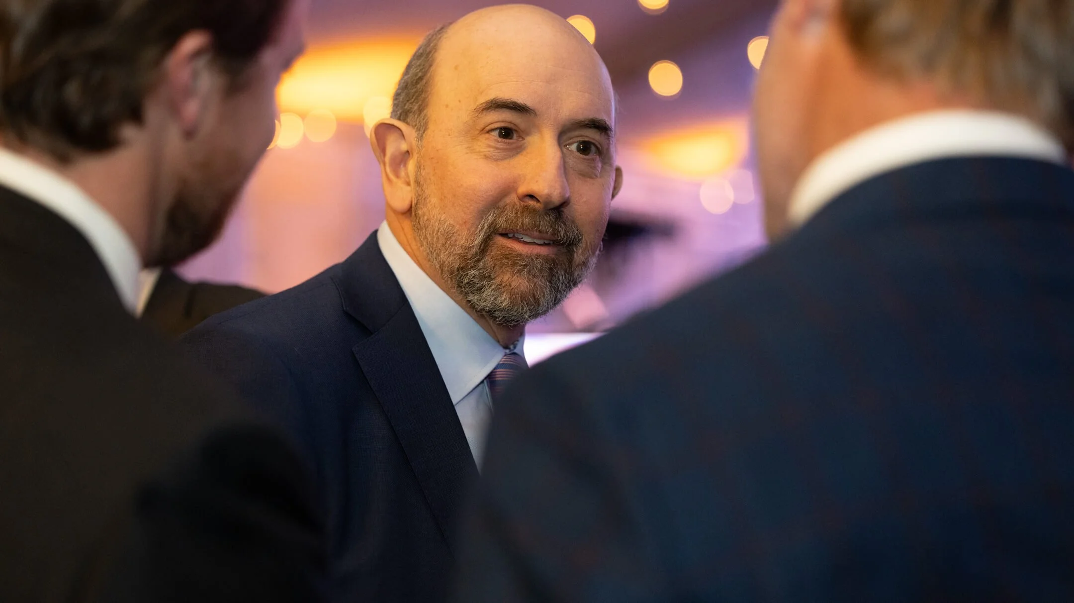 men in suits speaking