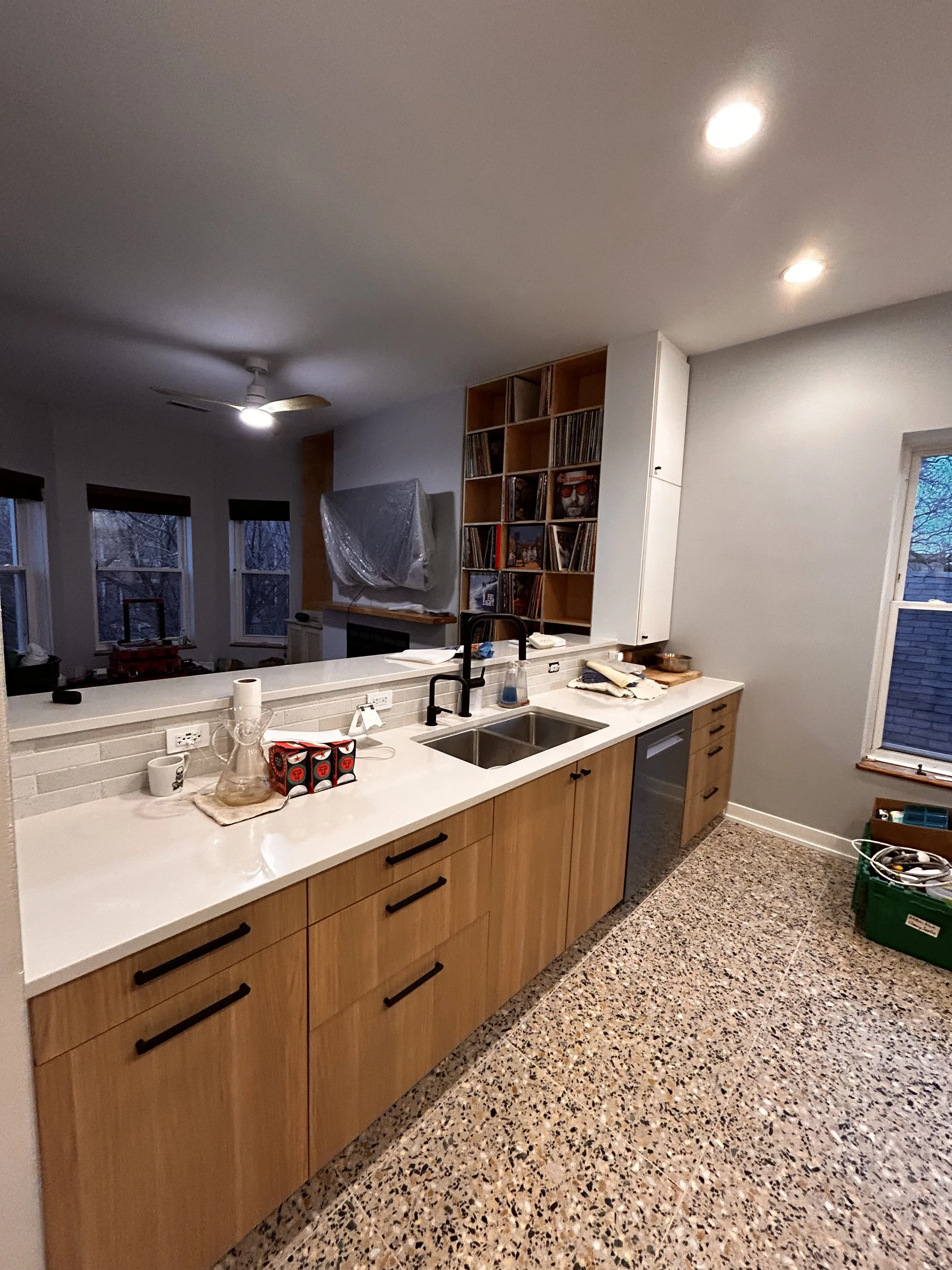 Dishwasher, disposal, water filter installed and plumbing hooked up. Custom built-in cabinets going in