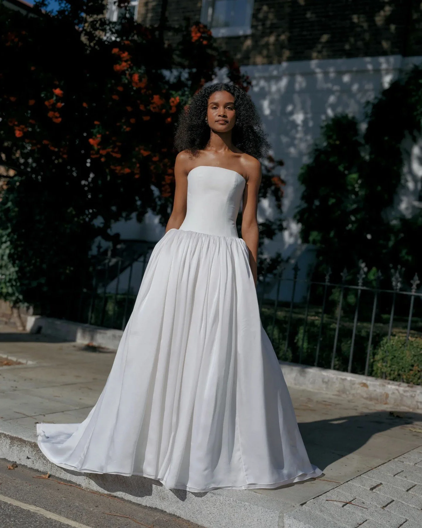 Daphne features a refined drop waist bodice that meets a gathered, georgette silk skirt - with a big kick out at the hip. It&rsquo;s romantic, modern and striking, and there are optional arm sashes, too.

Try Daphne exclusively at The Fall Bride this