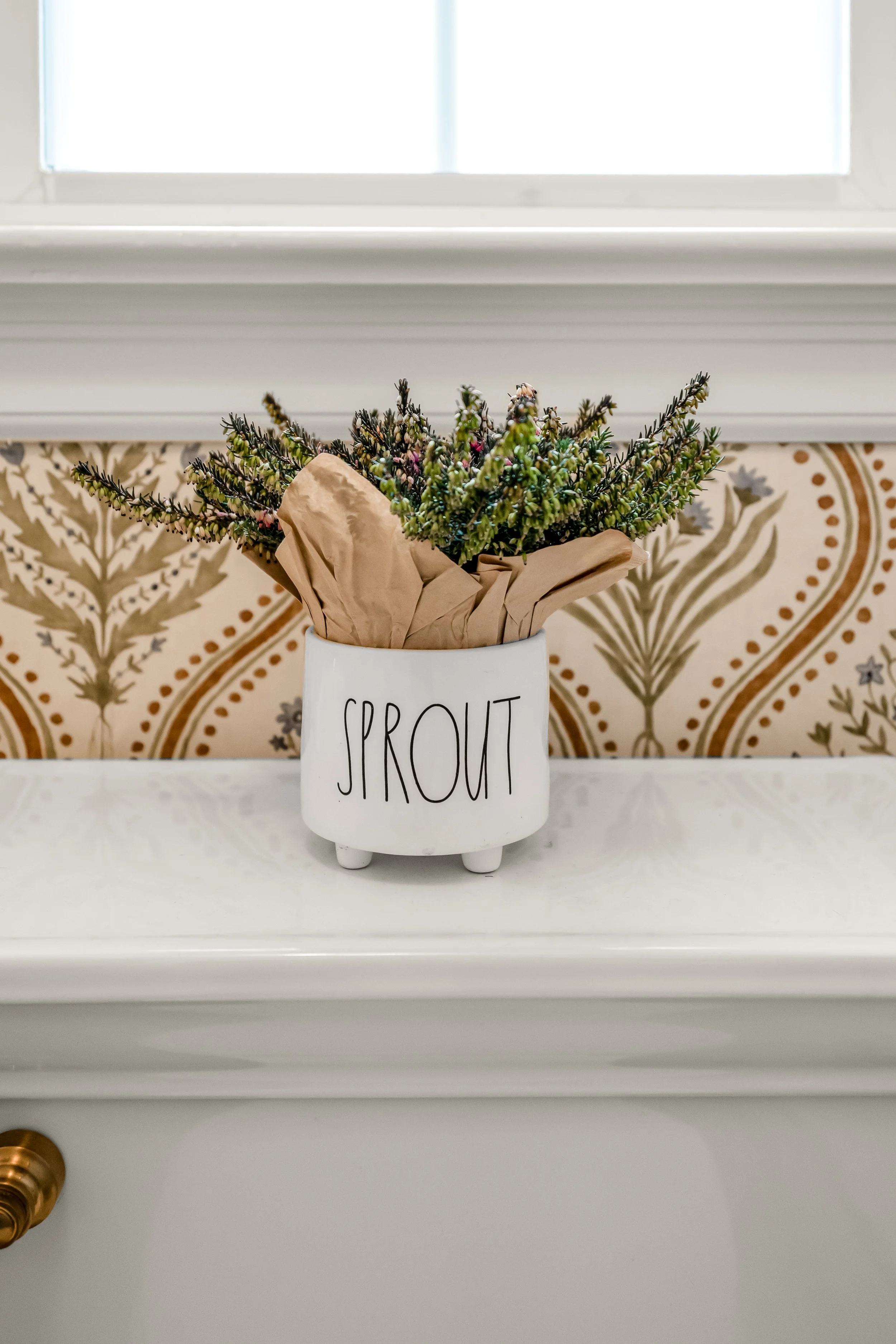 Powder room vanity and finishes in a Williamsburg, VA remodel created by converting the home’s former laundry room into a guest powder bath. Designed by AWH Interiors.