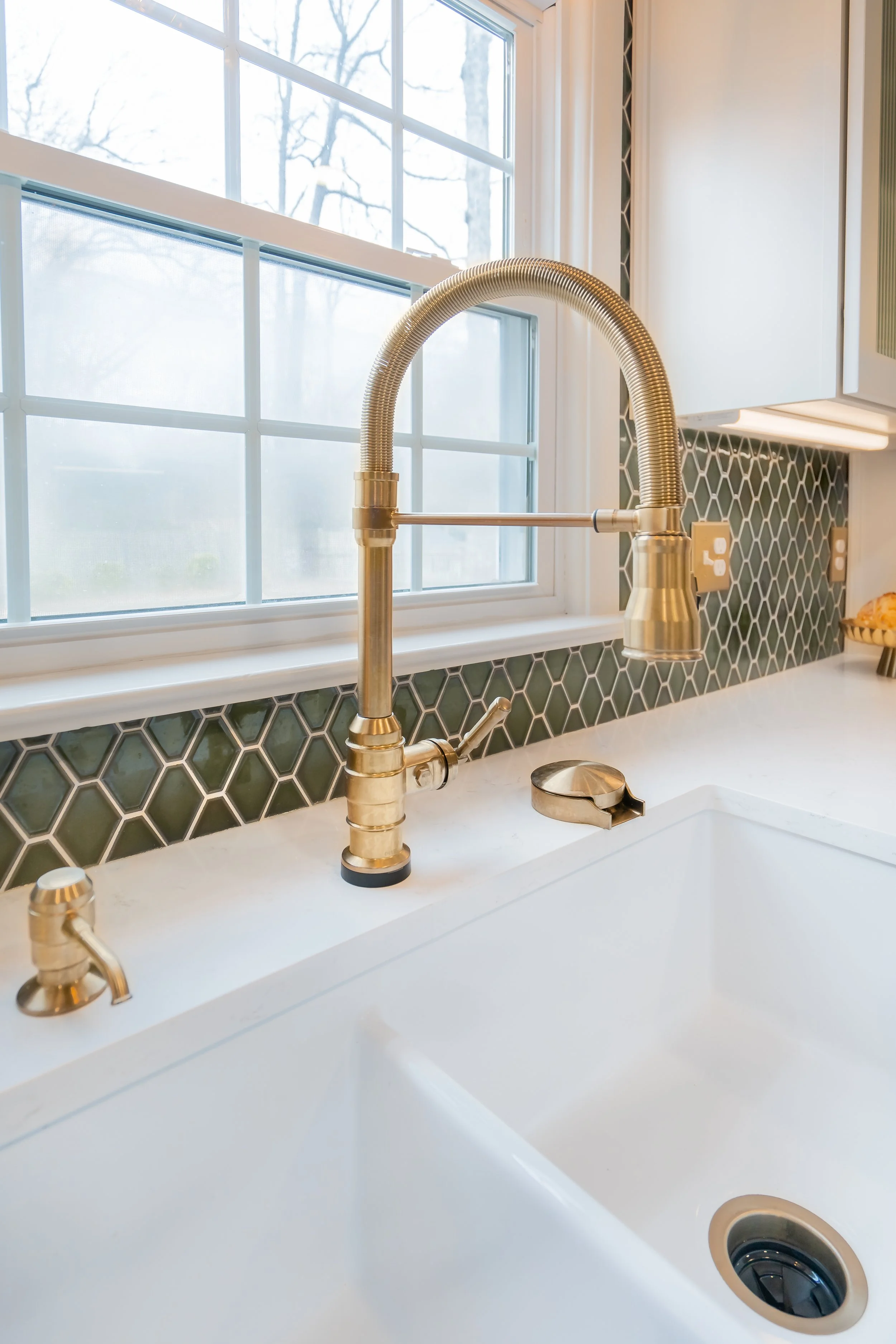 Williamsburg, VA custom galley kitchen remodel with terracotta hex tile floors, white cabinetry, chef-grade range, and brass hardware by AWH Interiors.