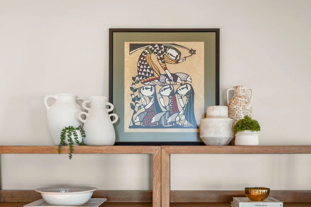 Spacious waterfront living room designed by AWH Interiors in Williamsburg, featuring soft blue accents, layered neutrals, and natural wood tones that echo the coastal surroundings.