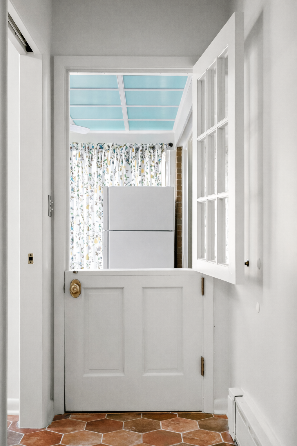 Dutch door detail connecting kitchen and pantry in a Williamsburg, Virginia remodel by AWH Interiors.