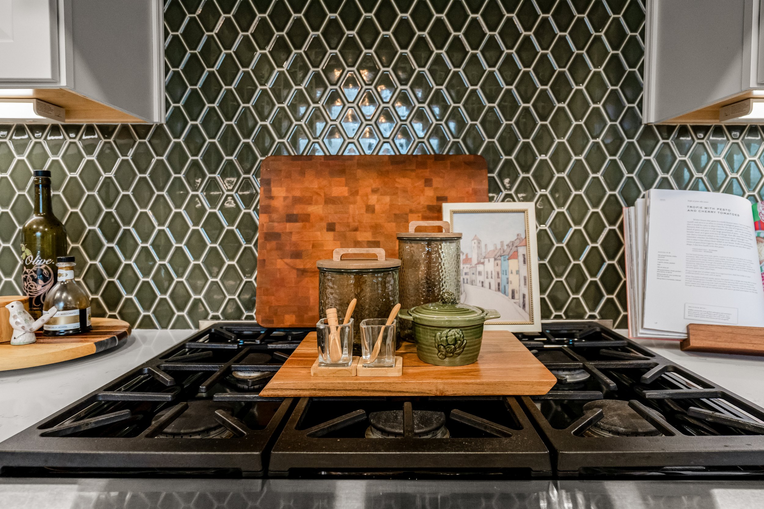 Williamsburg, VA custom galley kitchen remodel with terracotta hex tile floors, white cabinetry, chef-grade range, and brass hardware by AWH Interiors.