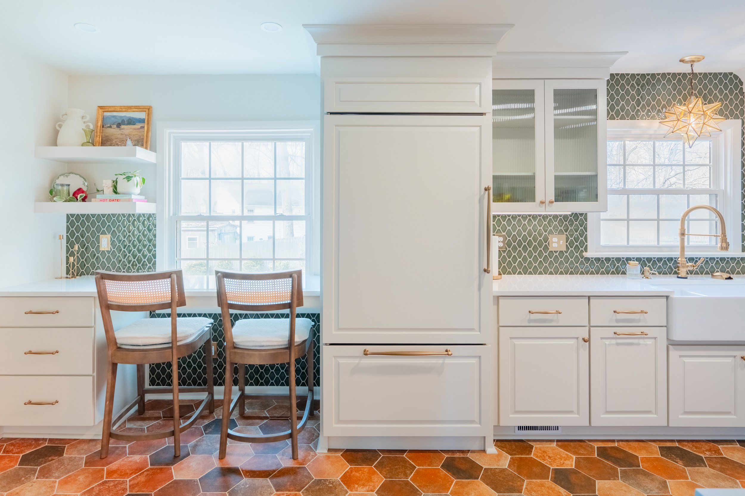 Paneled refrigerator and paneled dishwasher integrated into custom cabinetry in a Williamsburg, VA kitchen remodel by AWH Interiors.