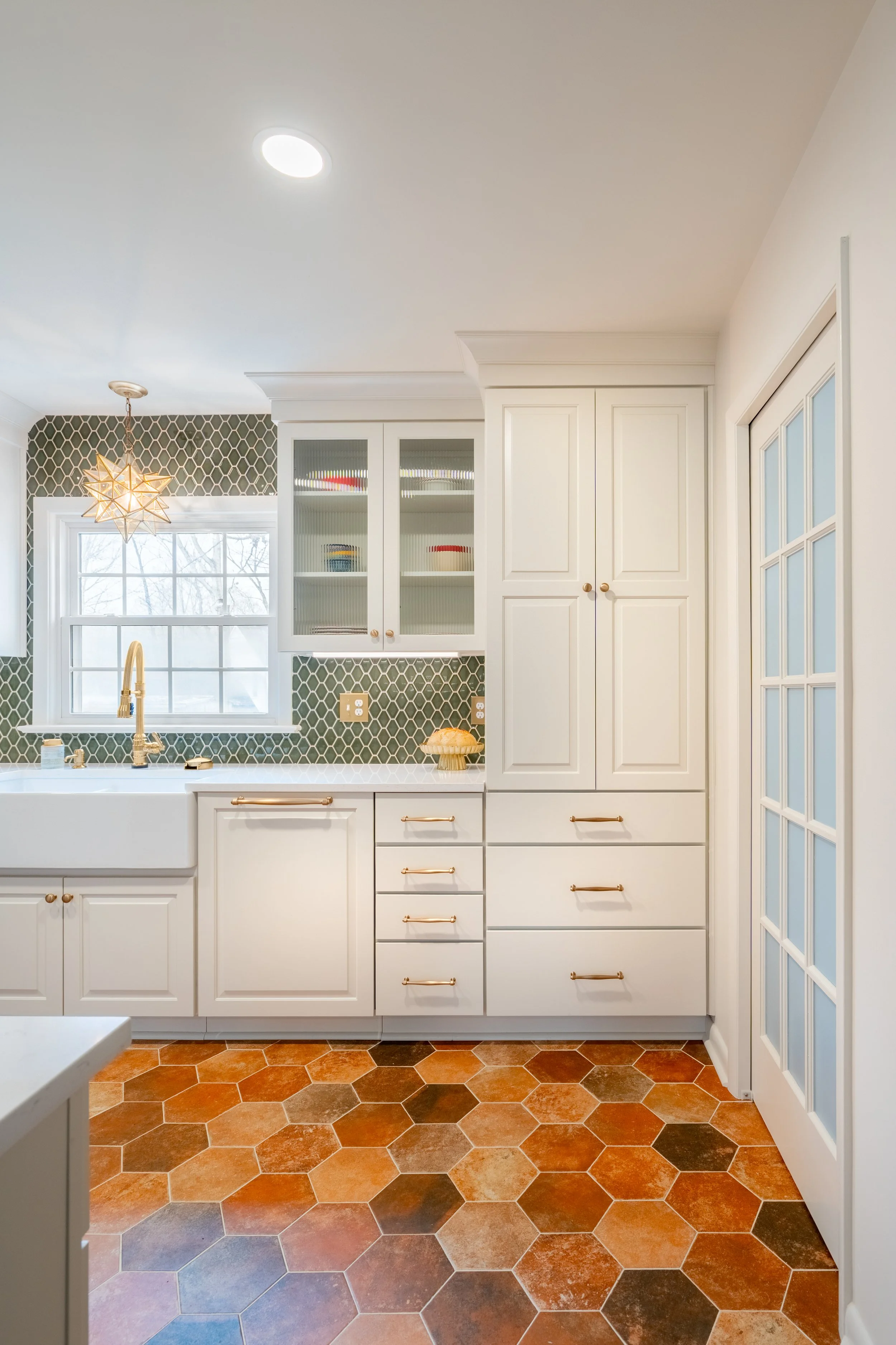 Paneled refrigerator and paneled dishwasher integrated into custom cabinetry in a Williamsburg, VA kitchen remodel by AWH Interiors.