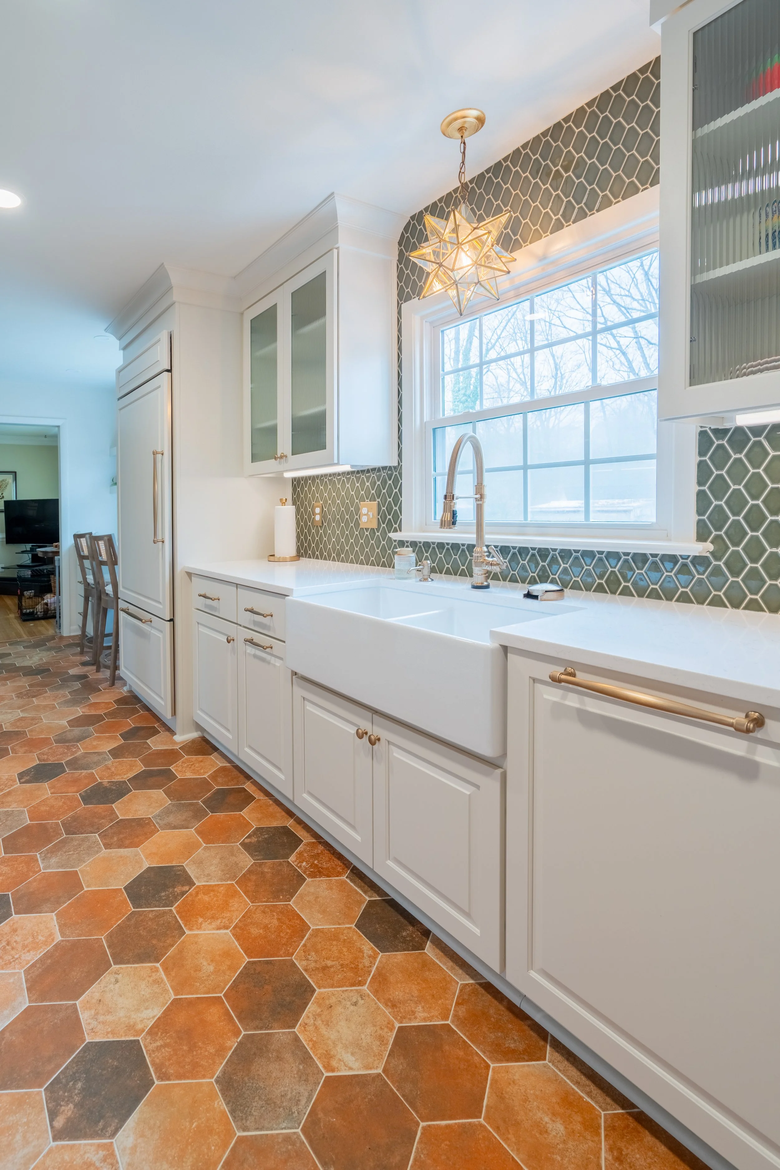 Paneled refrigerator and paneled dishwasher integrated into custom cabinetry in a Williamsburg, VA kitchen remodel by AWH Interiors.