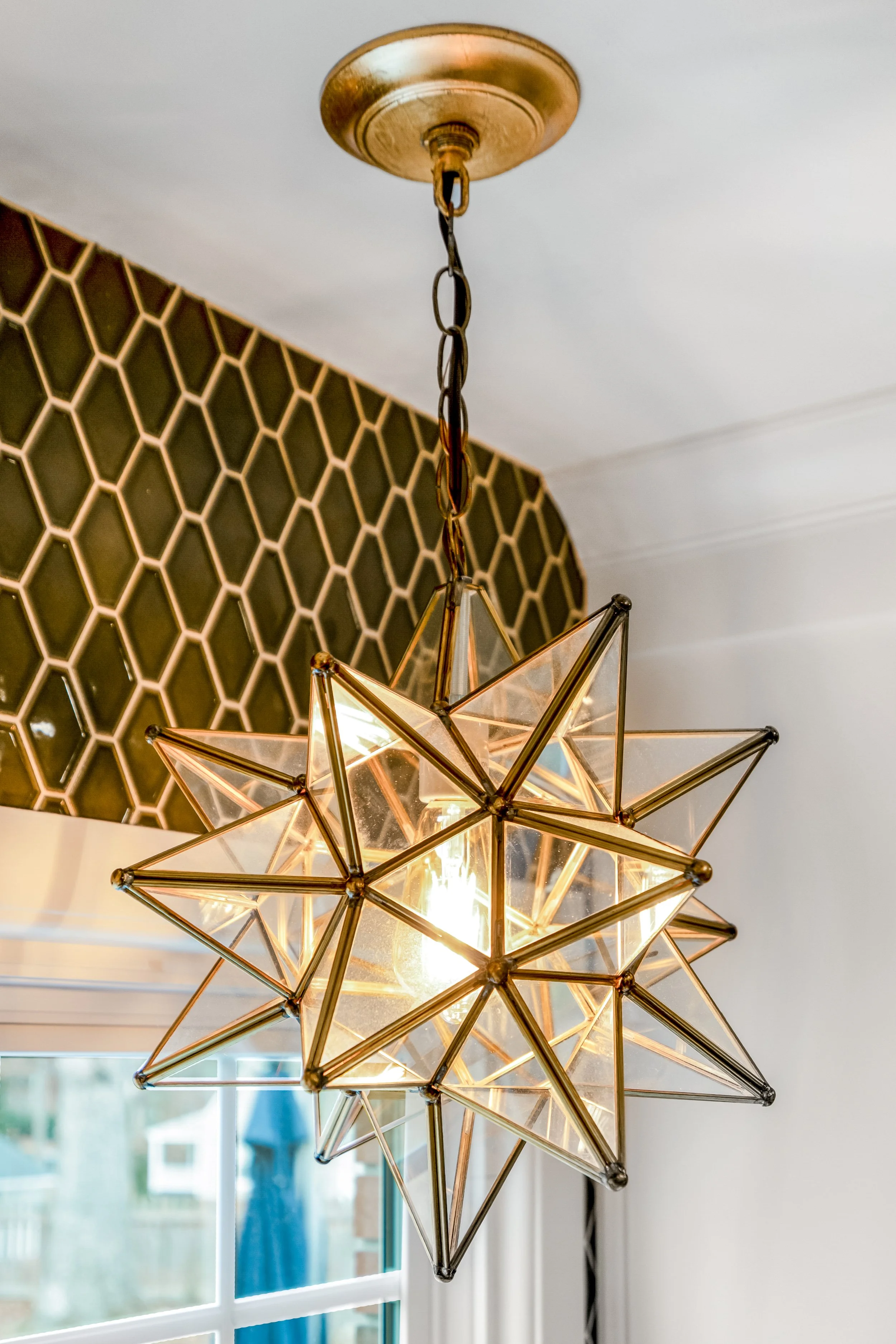 Williamsburg, VA custom galley kitchen remodel with terracotta hex tile floors, white cabinetry, chef-grade range, and brass hardware by AWH Interiors.