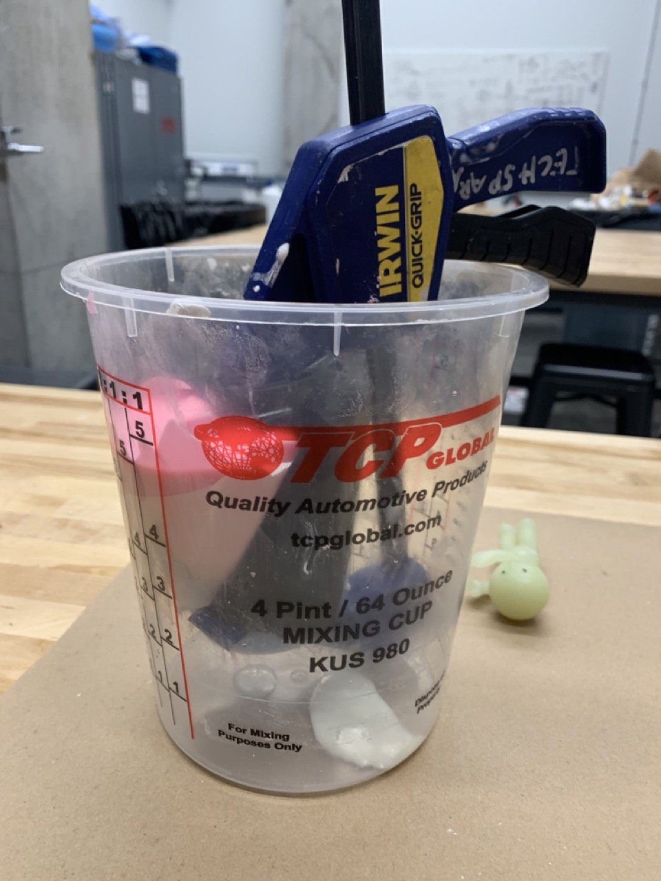 The mold being held together with a clamp while the resin is setting inside