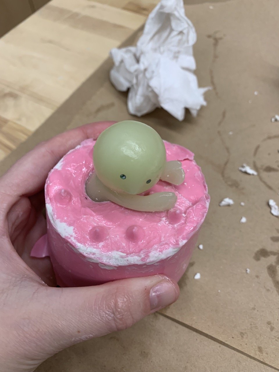 The pink is the first half of the silicone mold. The raised bumps allow for alignment when the second half is cast.