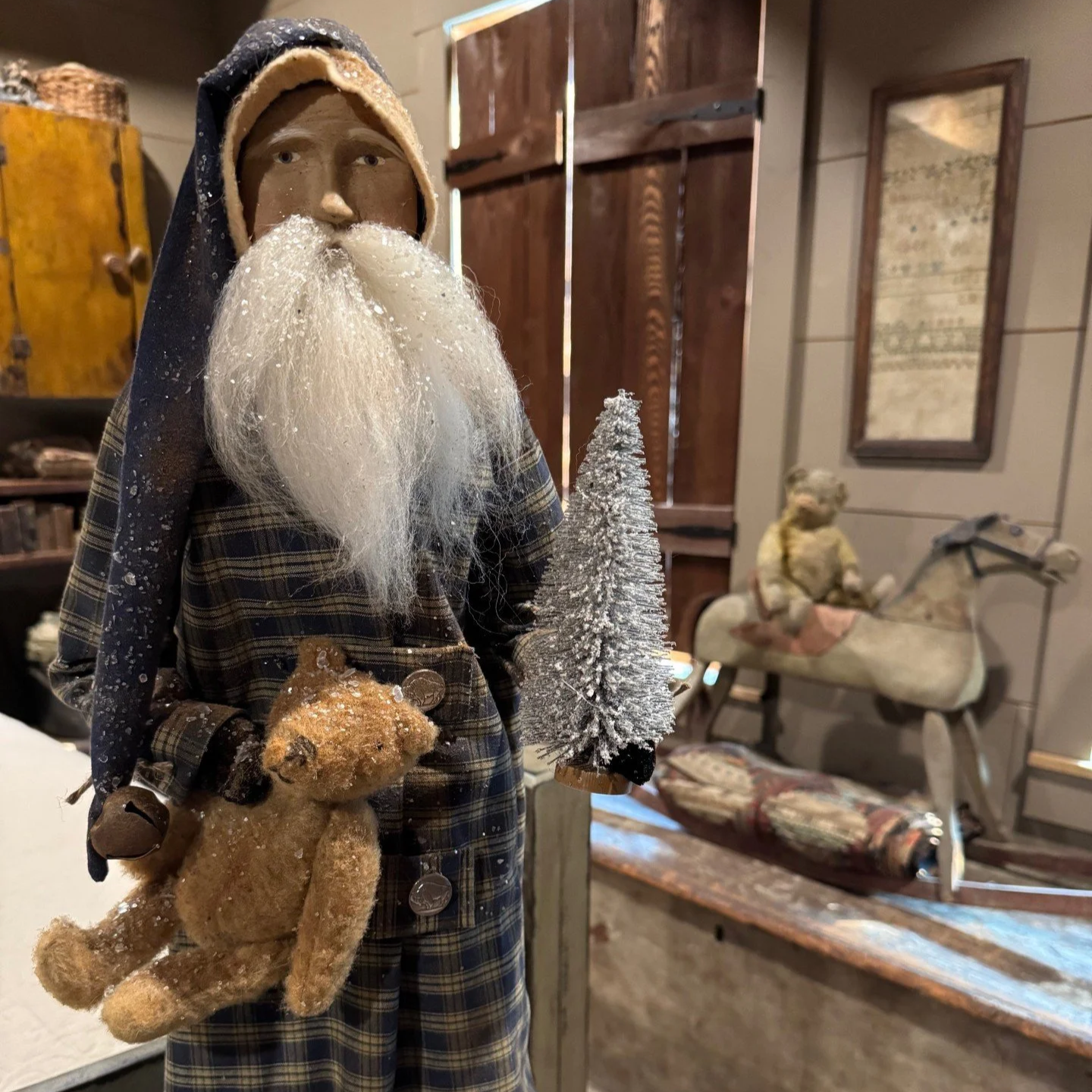 2026 Santa wearing a navy homespun night shirt holding a bear