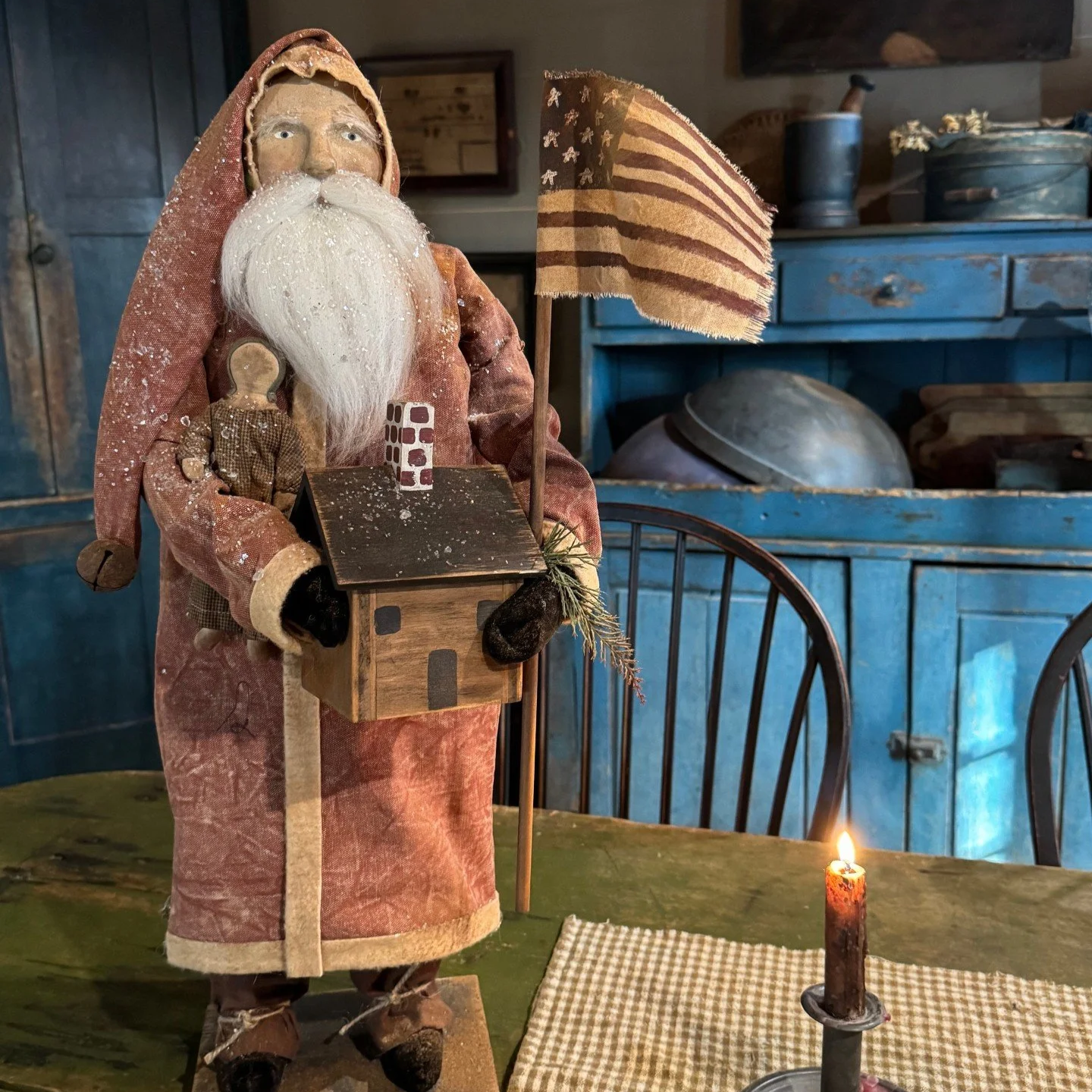 2026 Tall Santa wearing a red coat holding a mustard doll house and doll