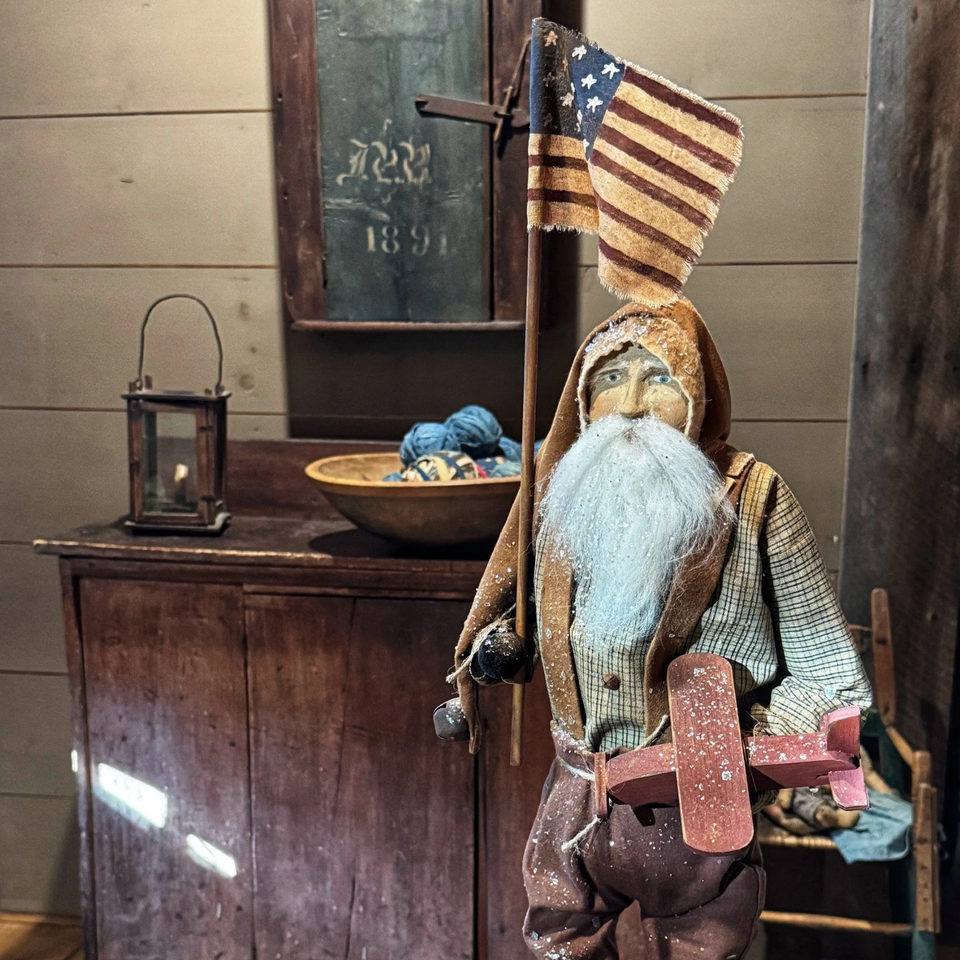 2026 Santa wearing overalls holding an airplane and flag