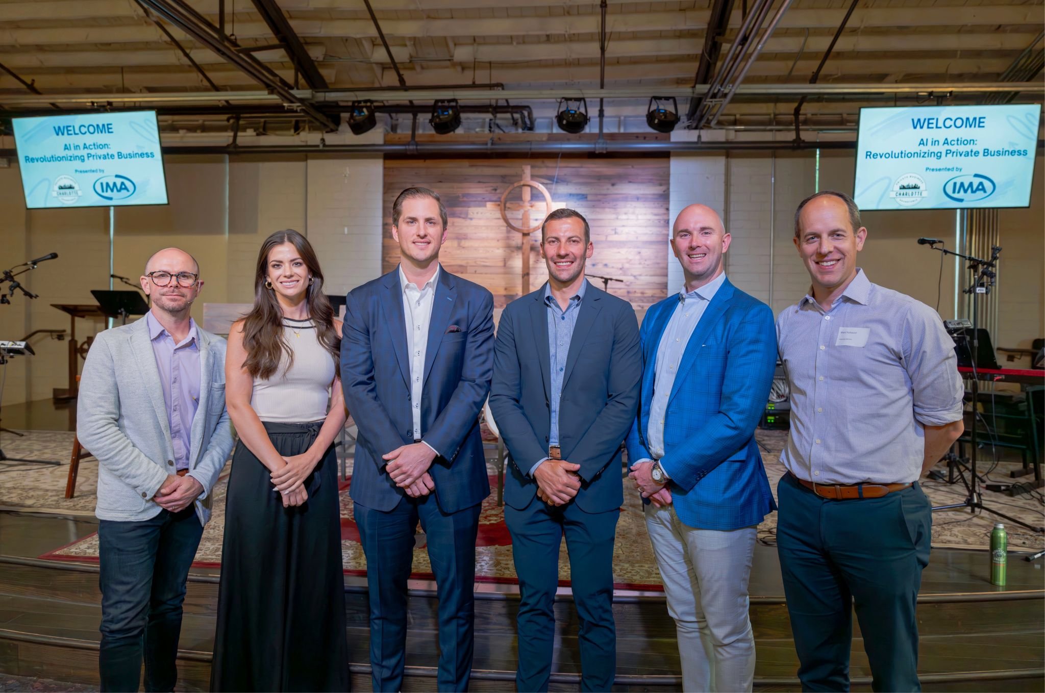 Group of seven professionals standing inside a church or conference room, with a wooden cross on the wall behind them, attending a seminar titled 'AI in Action: Revolutionizing Private Business'.