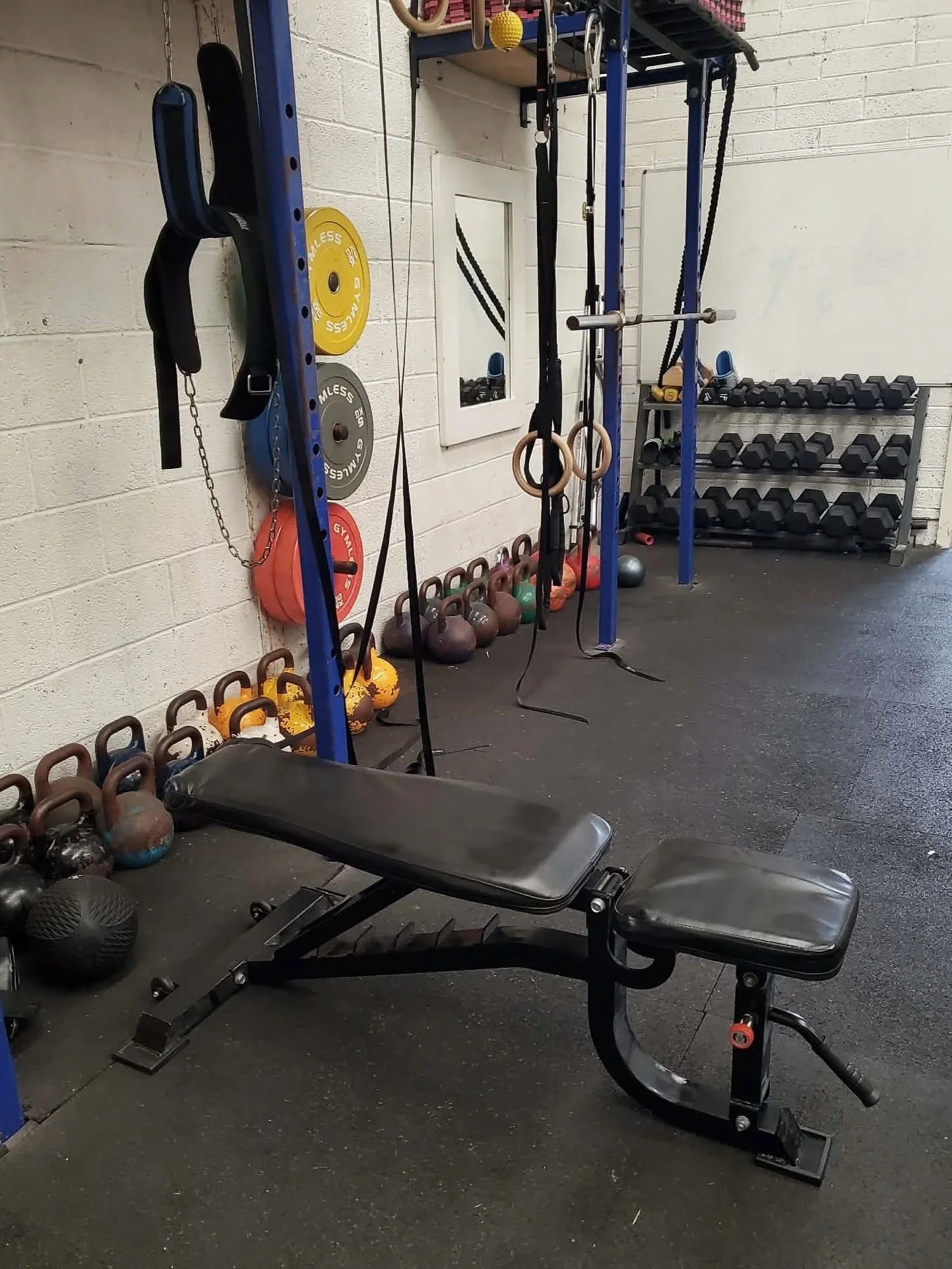 Weight room with strength and conditioning equipment. Barbell, kettlebell, dumbbell.