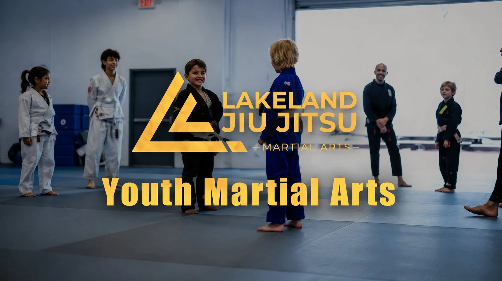 Children in martial arts uniforms standing in a ring during a class with an instructor watching. Text overlay reads 'Lakeland Jiu Jitsu - Martial Arts - Youth Martial Arts'.