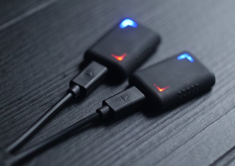 A pair of Corner boxing trackers on charge, blue indicator above red