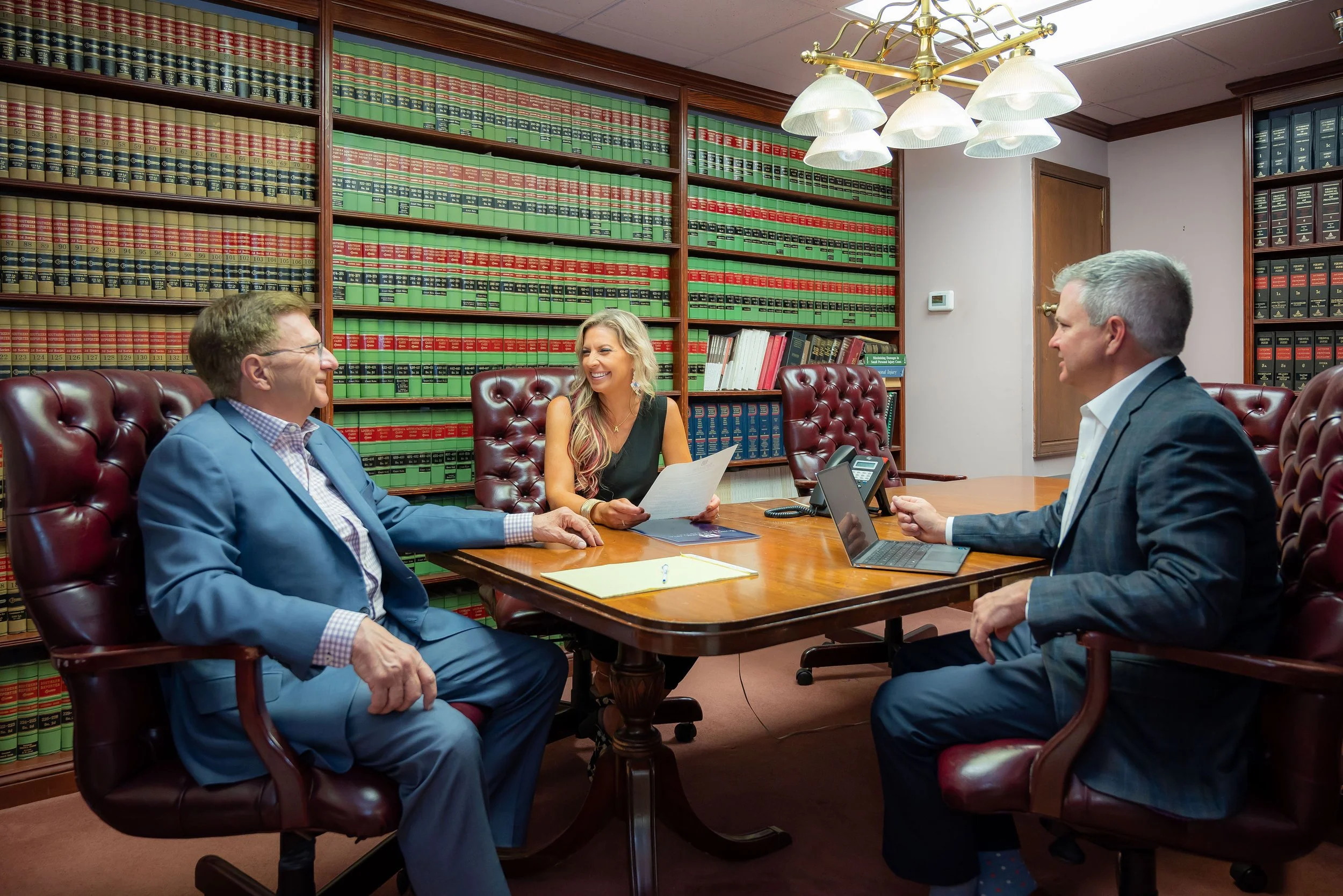 A Bono Law Firm attorney meeting with a client at the firm's Metairie office.