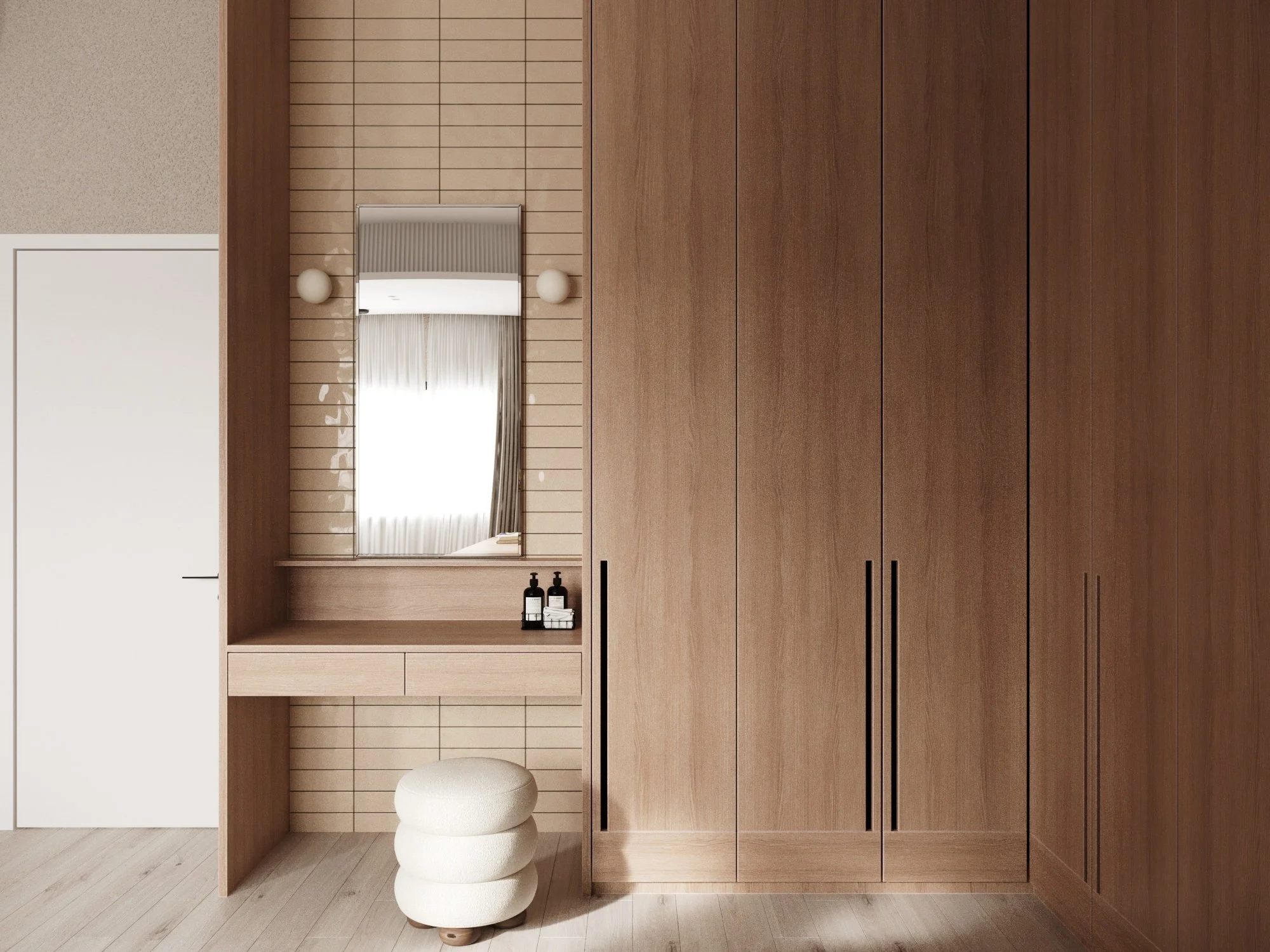 A modern bedroom with a large wooden wardrobe, a vanity area with a mirror, two skincare bottles on the vanity, a small round cream-colored stool, and a window with curtains reflected in the mirror.