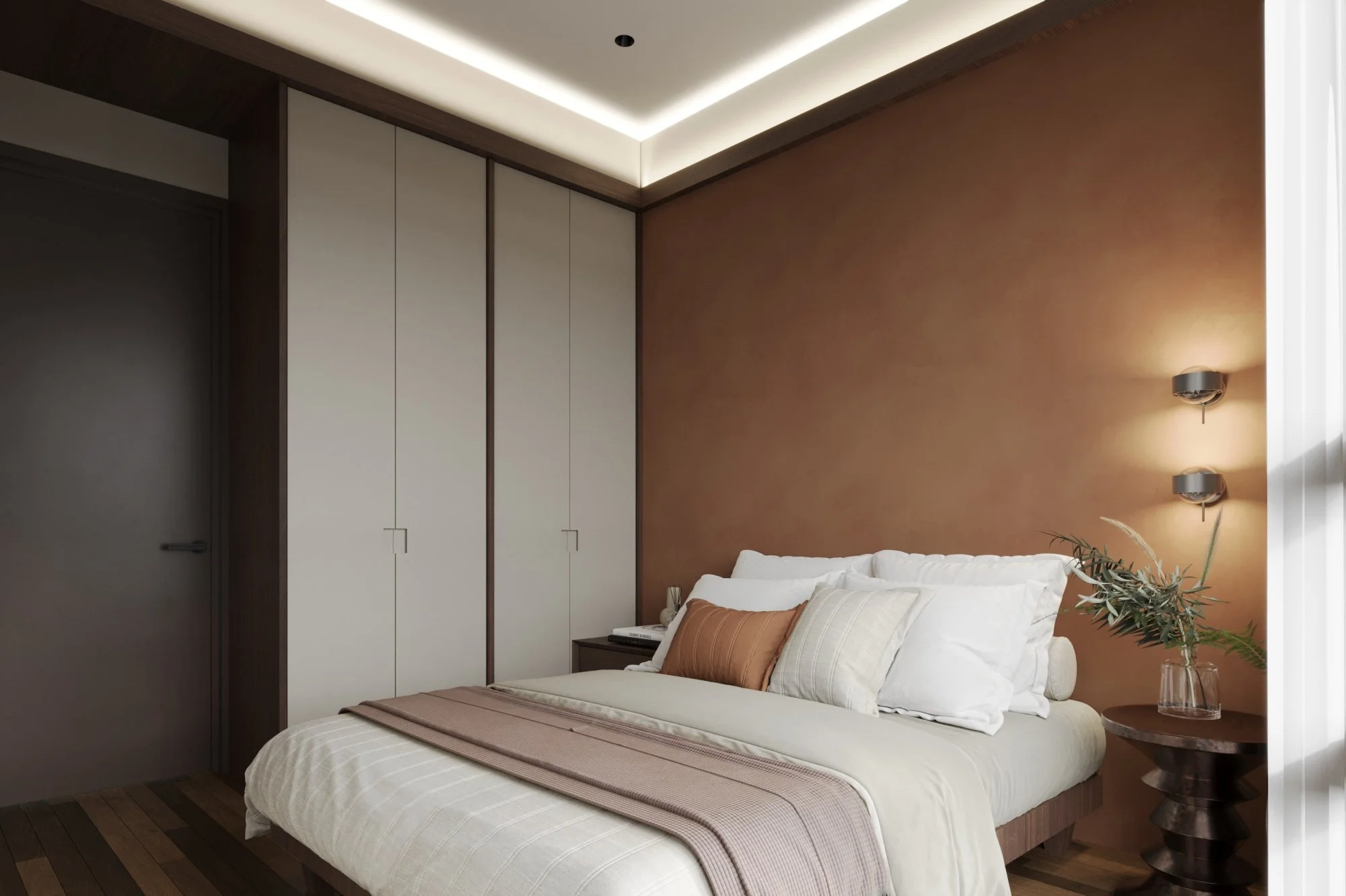 Modern bedroom with a bed featuring white, beige, and rust-colored pillows, a wooden side table with a vase of greenery, built-in wardrobe, and contemporary wall lights.