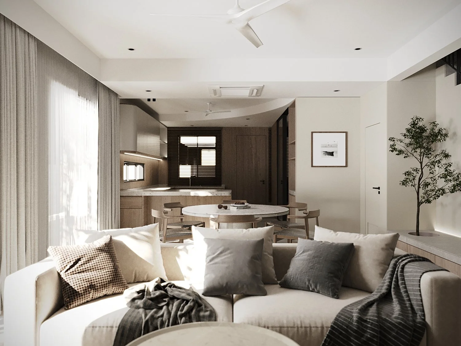 Modern living room with beige sofa and multiple pillows, dining table with chairs, large window with sheer curtains, indoor plant, and framed black-and-white art on the wall.