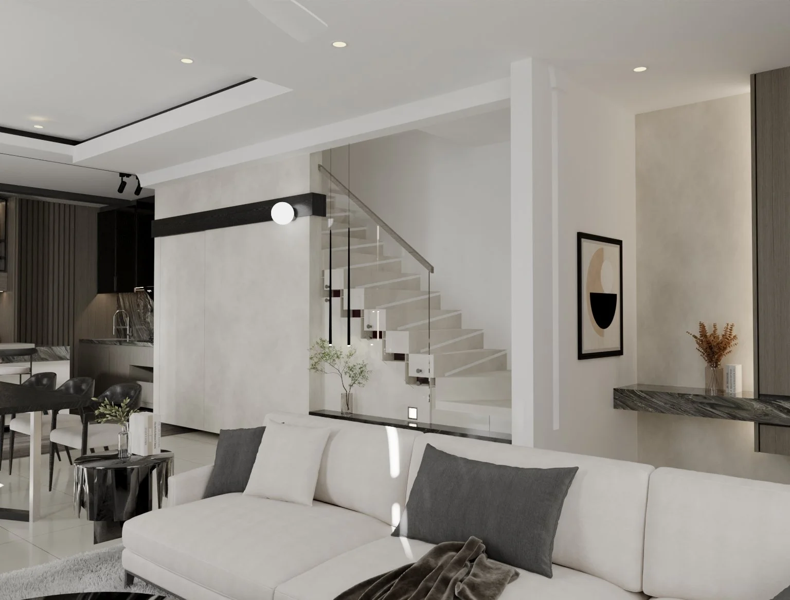 Modern living room with a white sofa, gray pillows, black side table, and artwork on the wall, overlooking a staircase with glass railing.