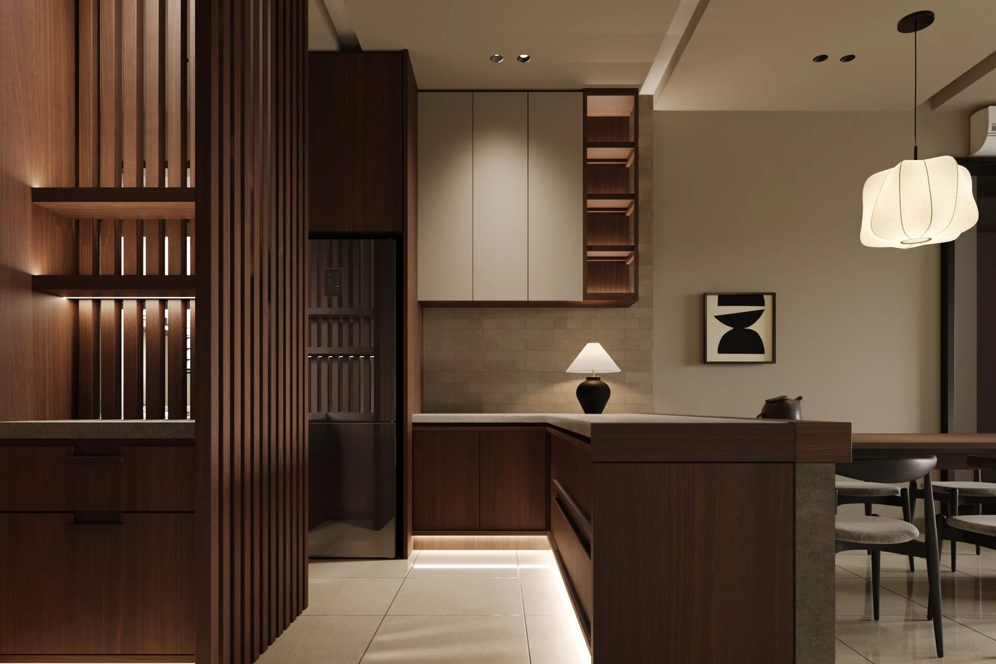 Modern kitchen with dark wood cabinetry, beige walls, a small table lamp, abstract black-and-white wall art, and contemporary lighting fixtures.