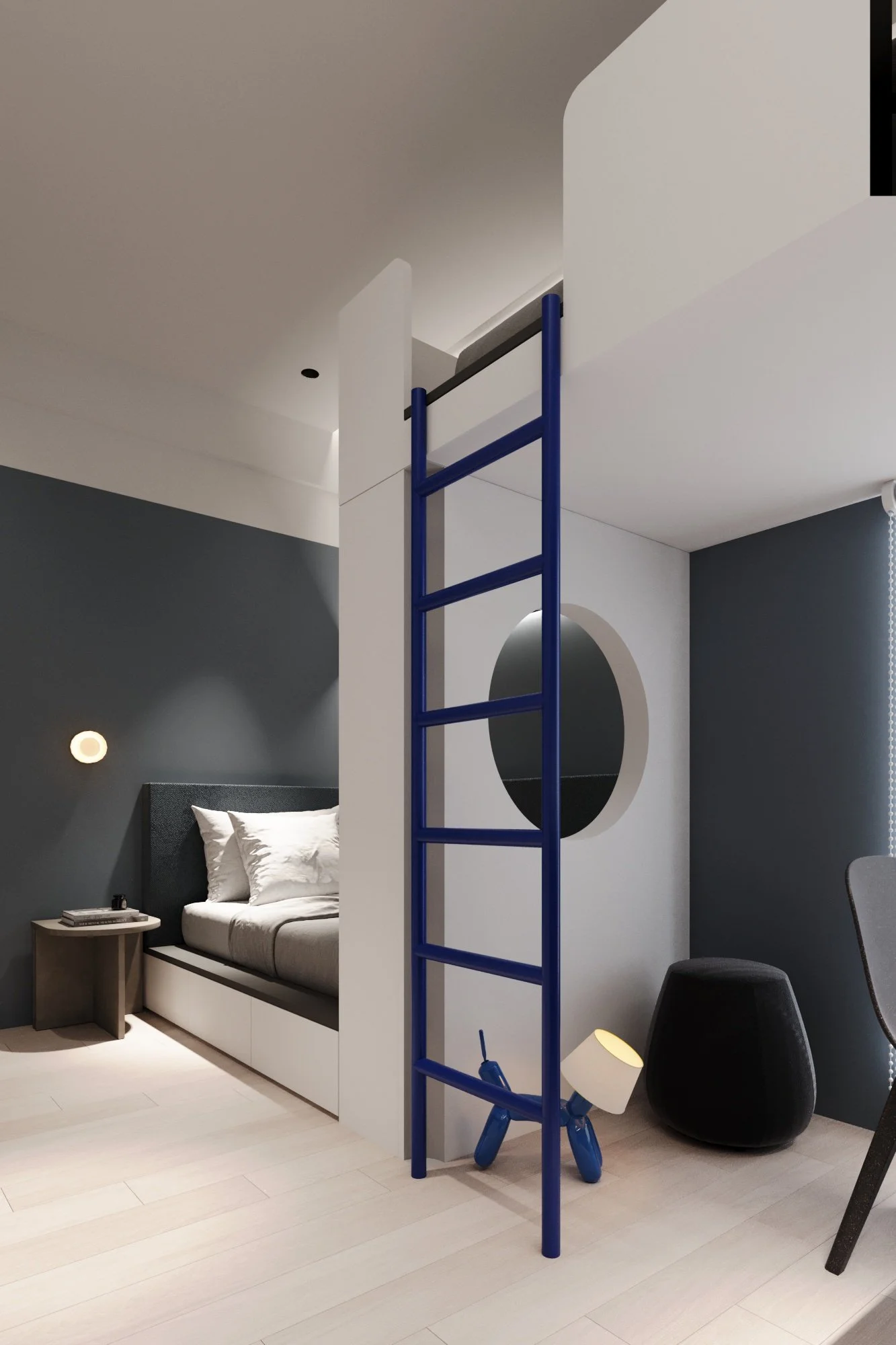 Modern bedroom with gray accent wall, bed with white bedding, small nightstand, black wall sconce, round mirror, blue ladder, inflatable dog lamp, black ottoman, gray chair, window with blinds.