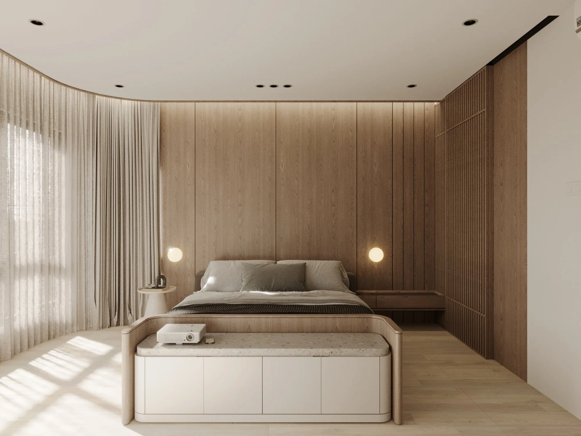 Minimalist bedroom with a wooden headboard, white curtains, beige bedding, round wall lamps, a white storage bench with a projector, gray pillows, and a side table with a lamp.