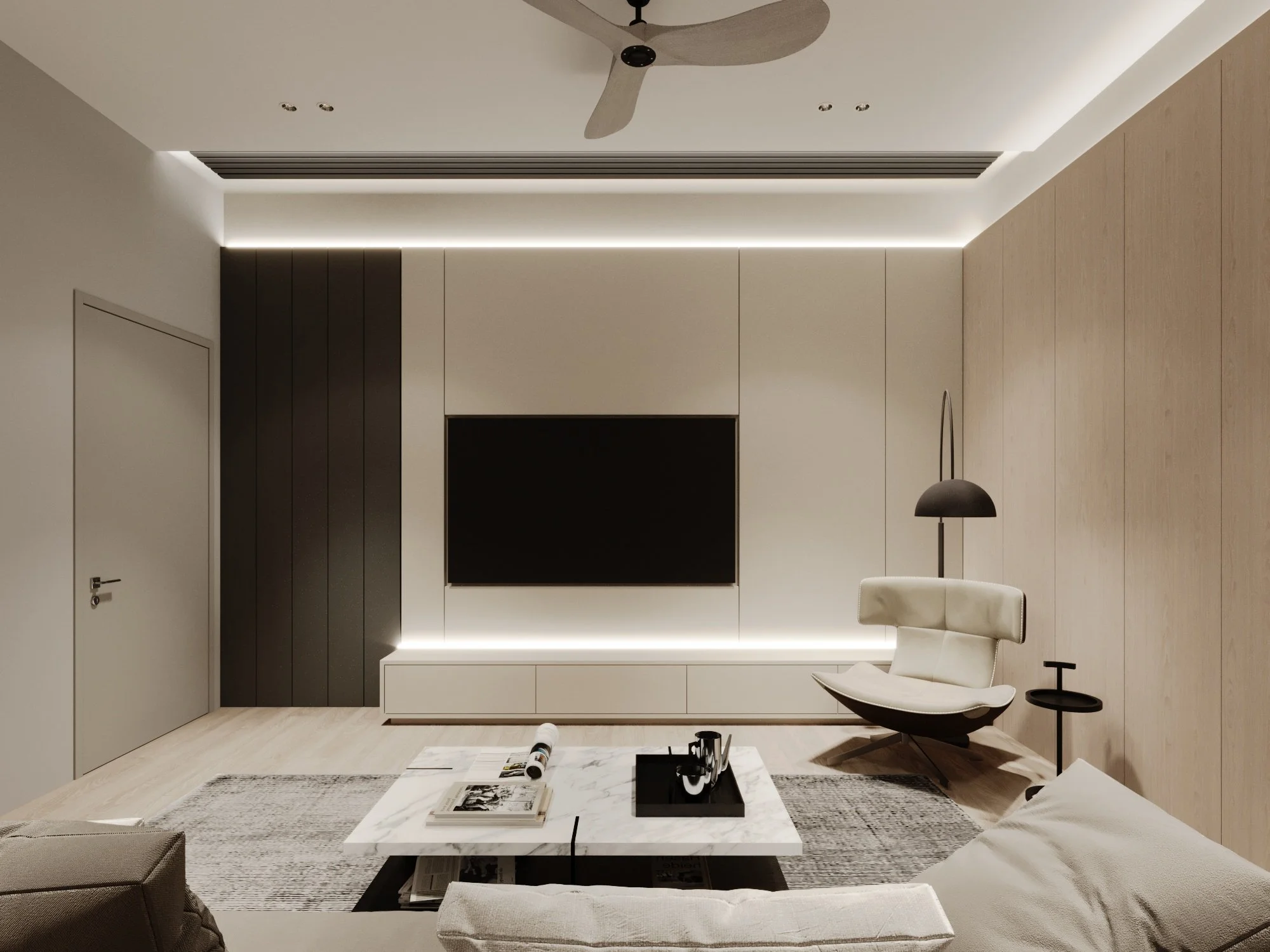 Modern living room with a mounted flat-screen TV, an off-white armchair, a black floor lamp, a white side table, and a marble coffee table on a rug.