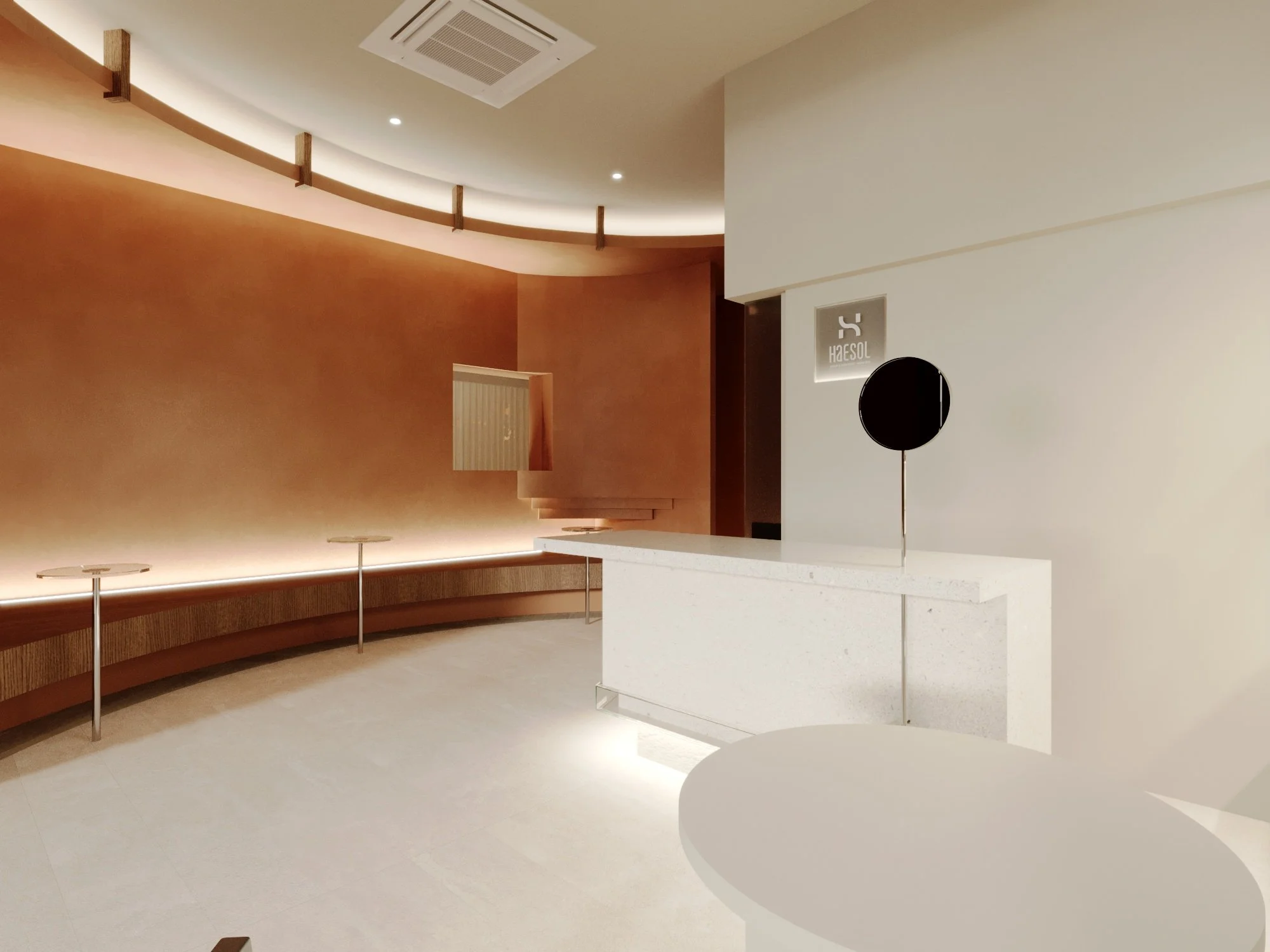 Modern minimalistic lobby with warm-toned wall and a white reception desk.
