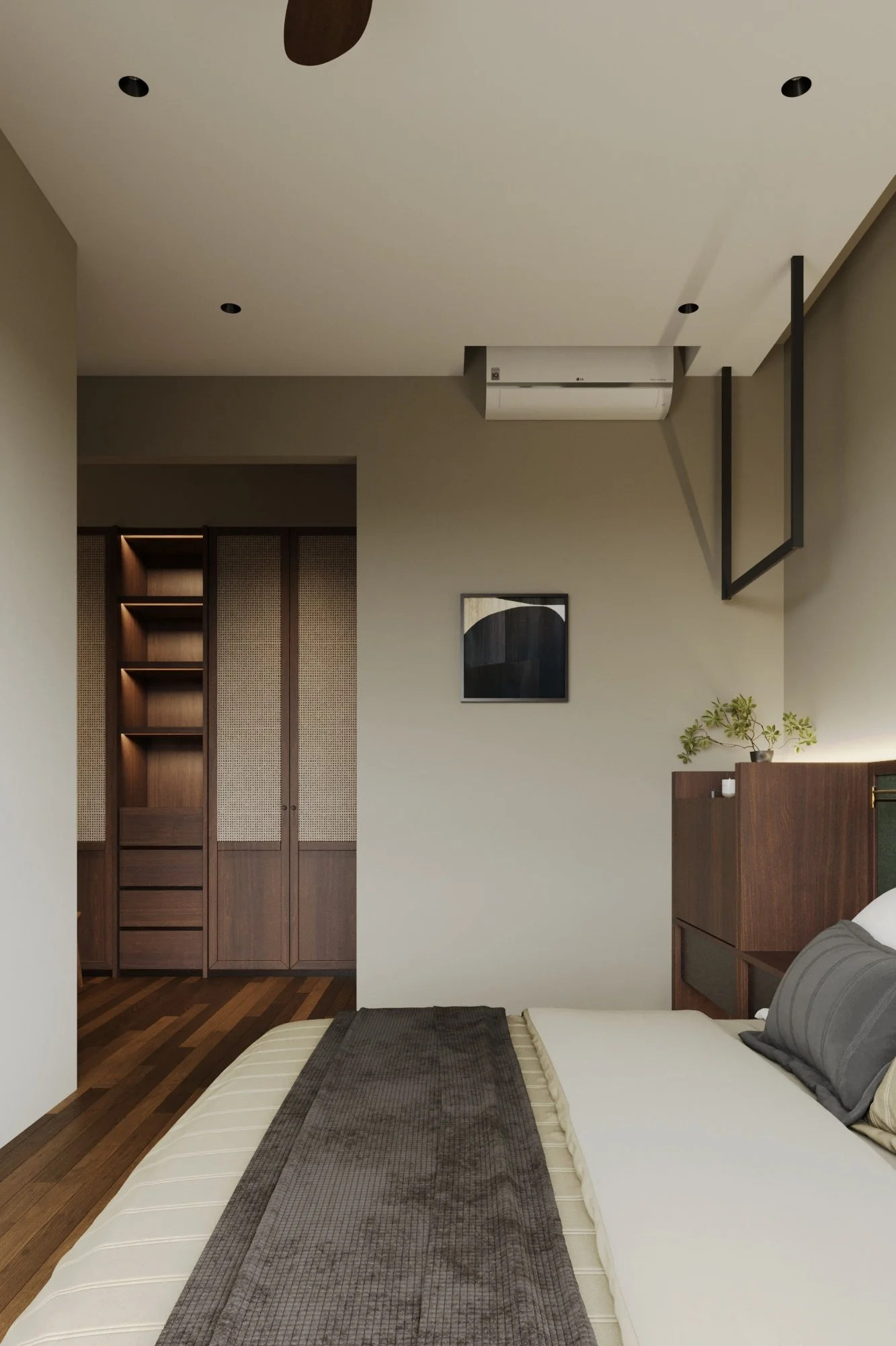 Modern bedroom with a bed, gray pillows, dark gray throw blanket, wooden flooring, and built-in wooden closet with sliding doors near the corner.