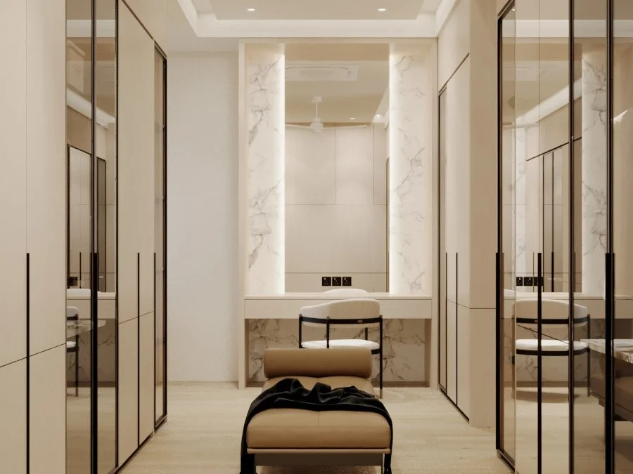 Elegant dressing room with marble walls, mirrored closets, a vanity table, and a cushioned bench.