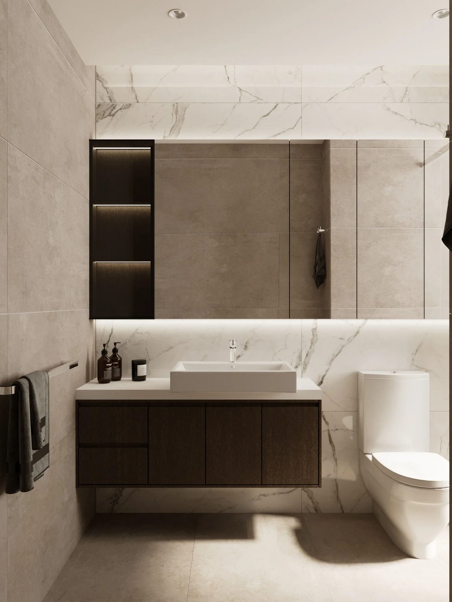 Modern bathroom with a white sink on a dark wood vanity, a toilet, a large mirror, and beige and marble wall tiles.