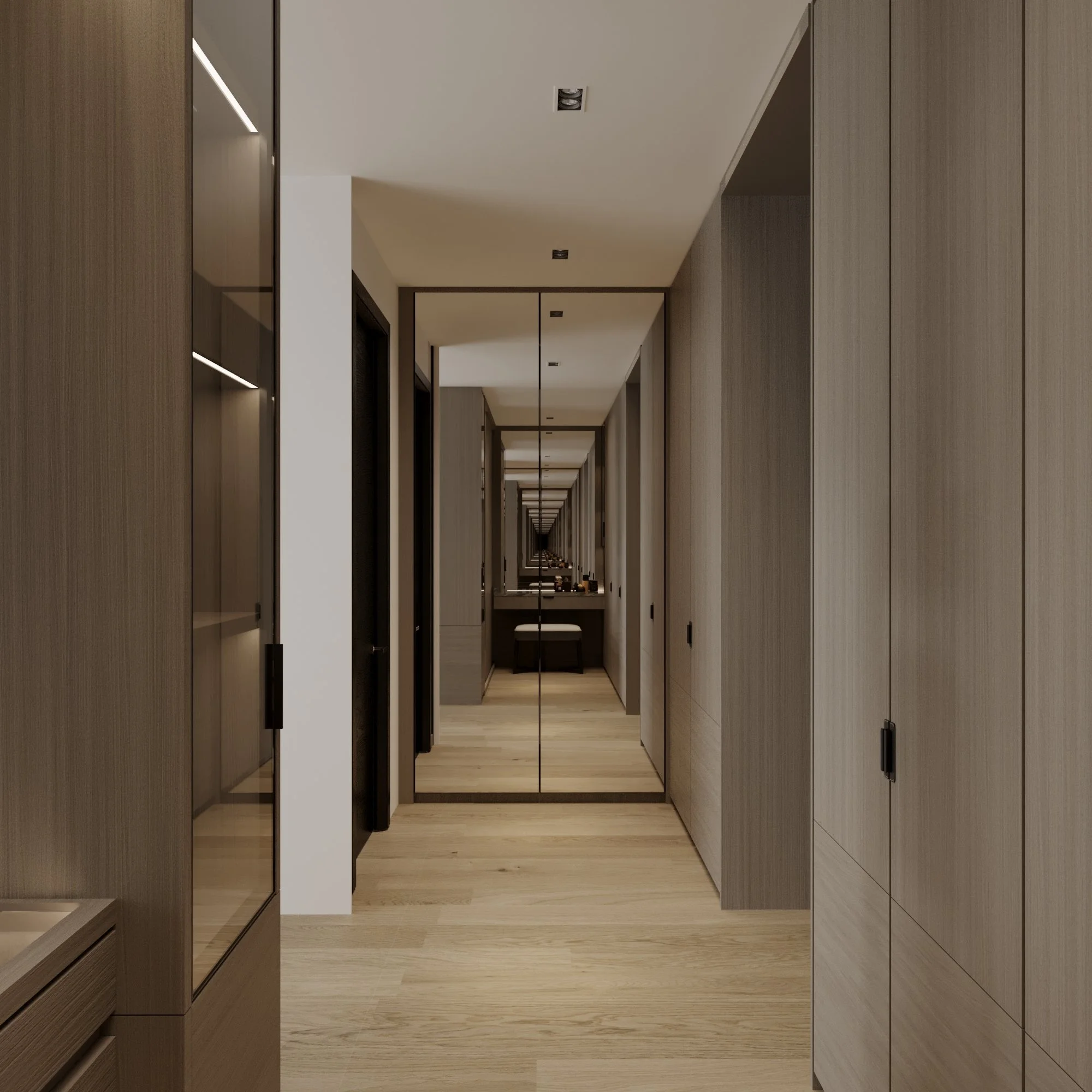 A hallway with wood-paneled walls, a full-length mirror, and a light wooden floor, extending into a room with a desk and stool in the background.