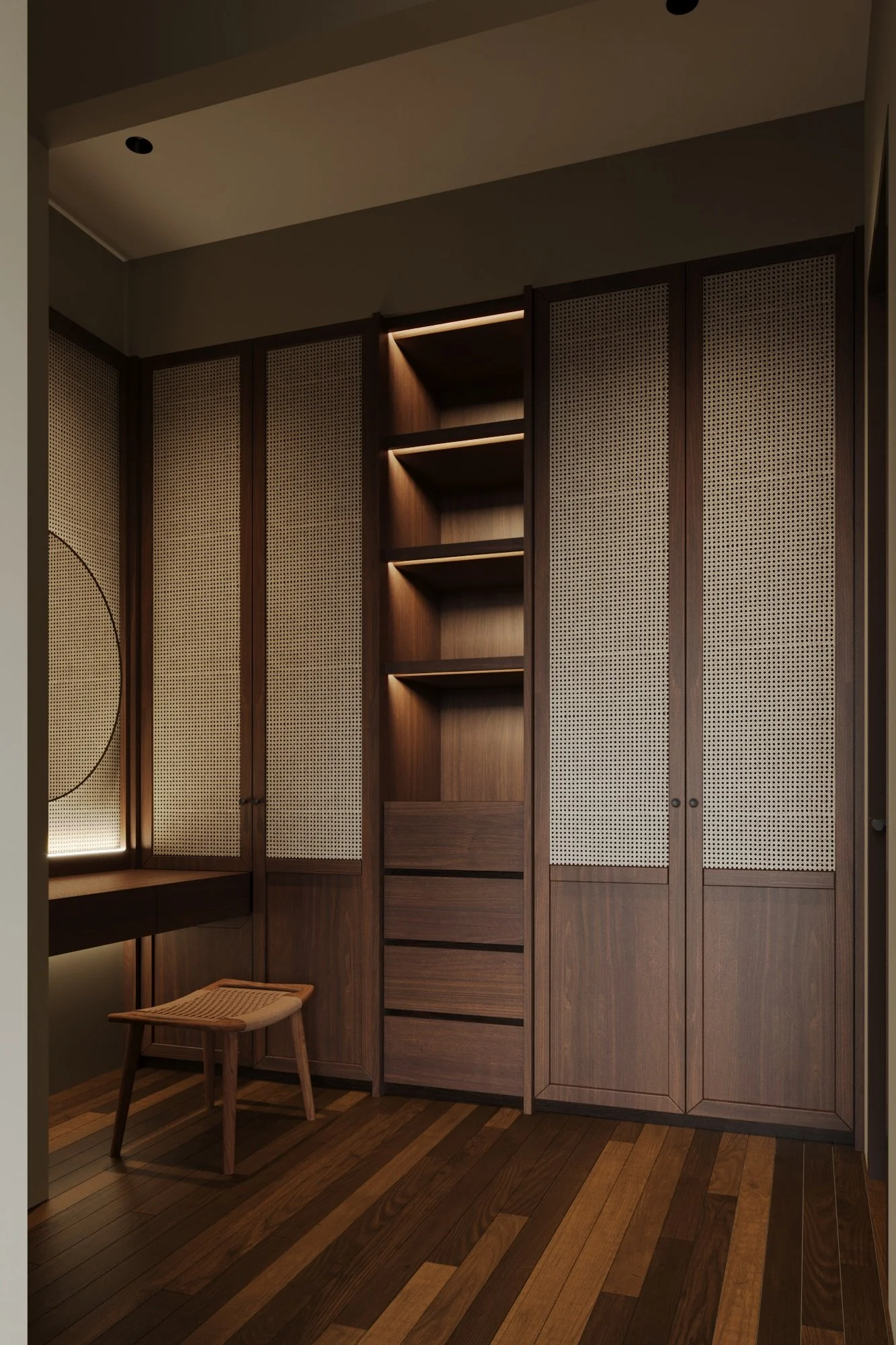 A room with dark wood built-in shelves, cabinets, and a small desk with a wooden stool, illuminated with soft lighting.
