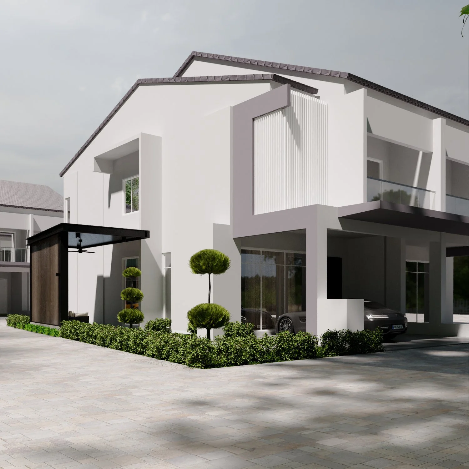 Modern white residential building with balconies, black car parked under a covered driveway, small landscaped trees and shrubs, and gray pavement in front.