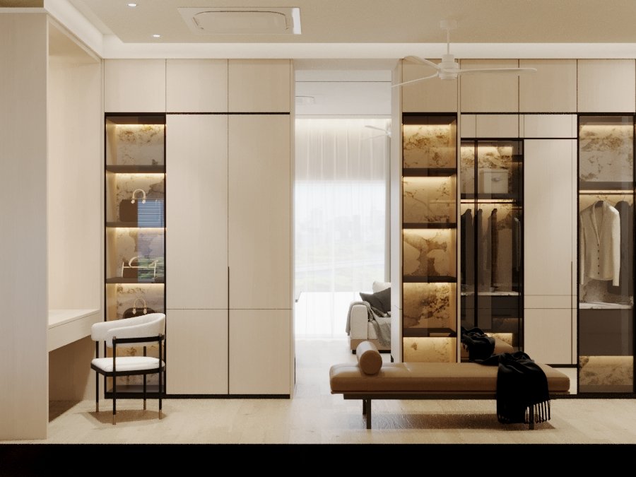 Modern bedroom with built-in closet with marble and glass doors, a small desk with a chair, a bench with a pillow, and a view of a sitting area with a sofa and large window.